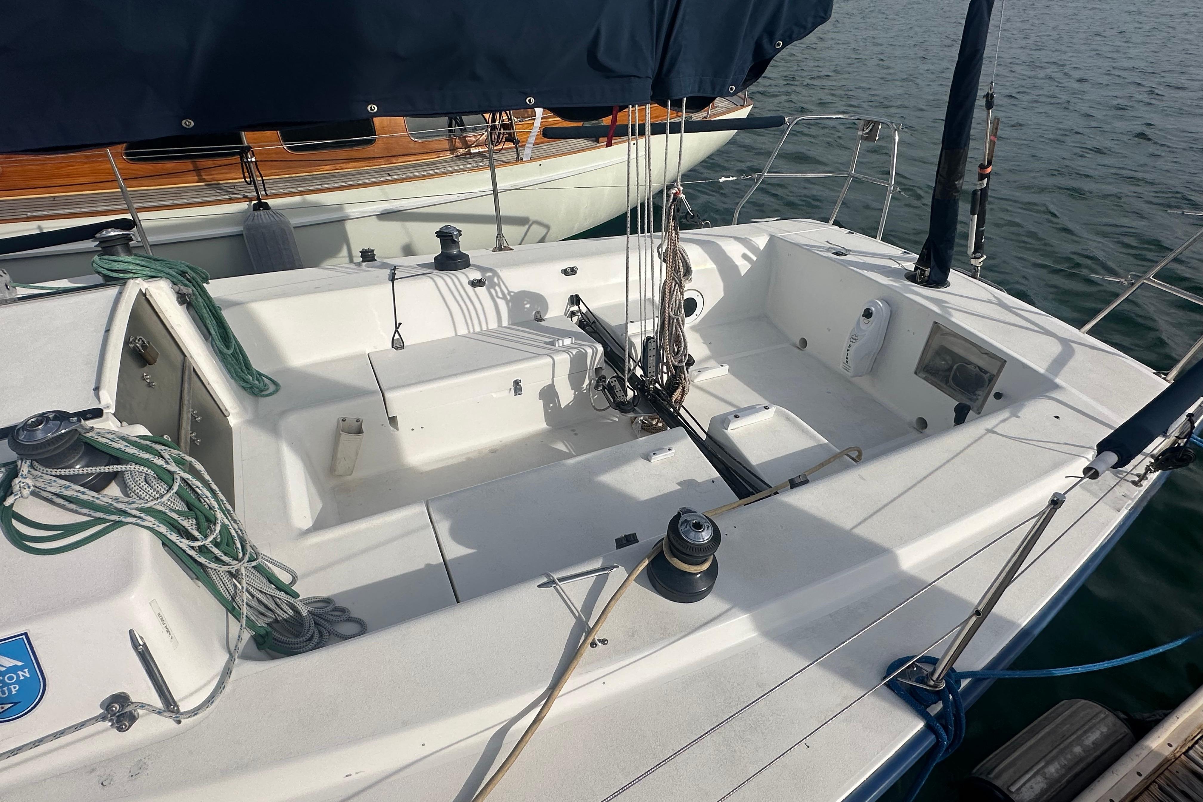 1998 J Boats J/105 sailboat cockpit with rigging and winches, docked on calm water.