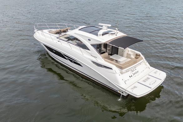 2016 Sea Ray Sundancer 510 yacht on calm water, showcasing sleek design and spacious deck.