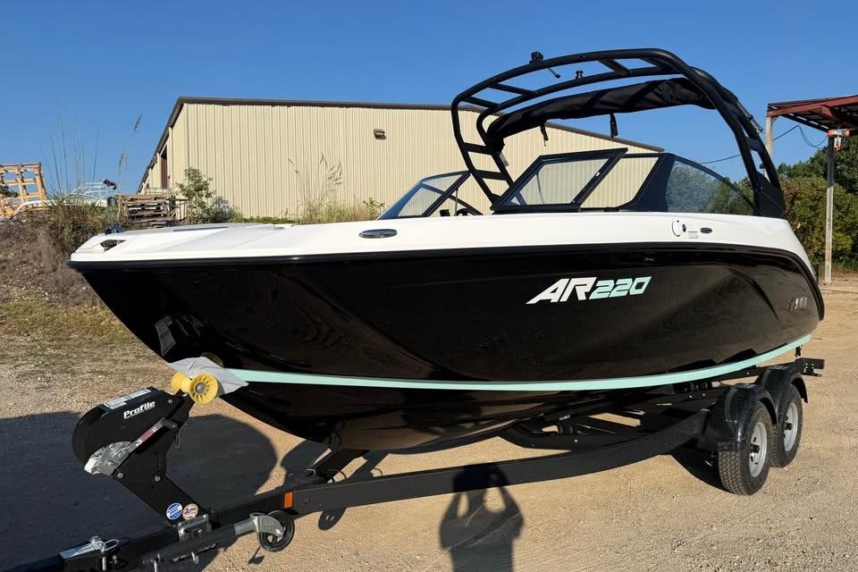 2026 Yamaha Boats AR220 on trailer, black and white design, parked outdoors.