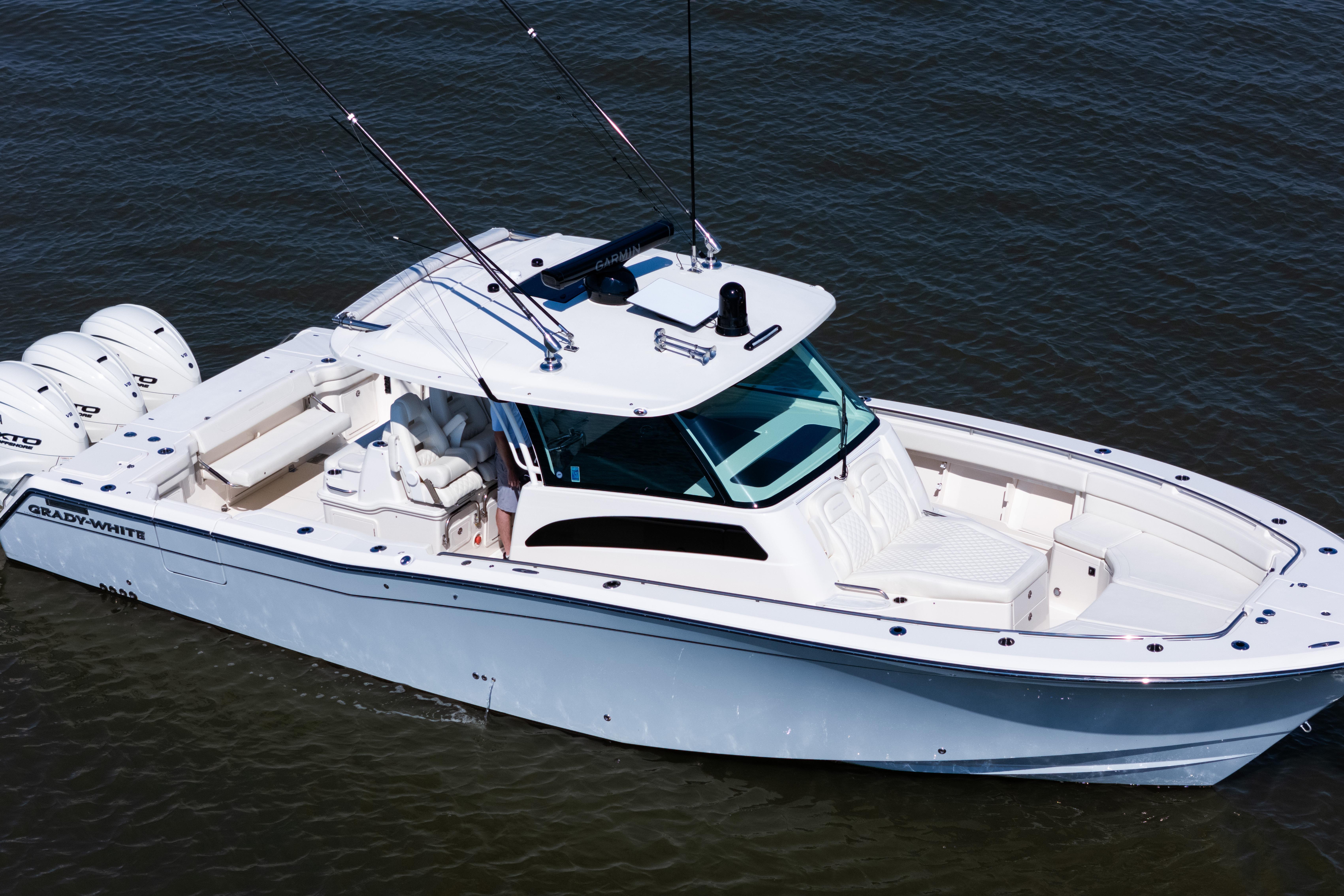 2025 Grady-White Canyon 386 boat on water, featuring sleek design and triple engines.
