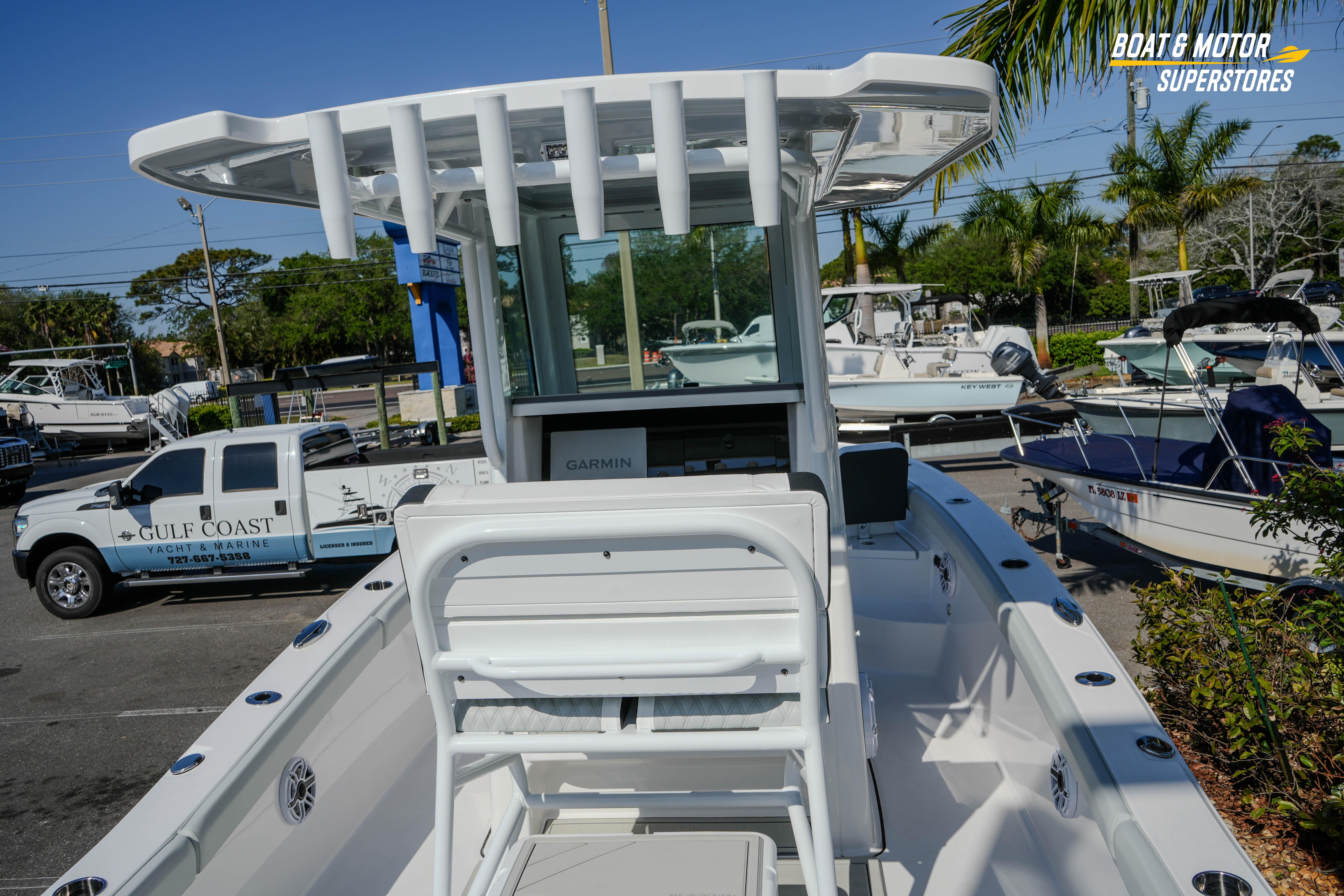 2026 Blackfin 242 HB boat at dealership, featuring sleek design and advanced Garmin navigation.