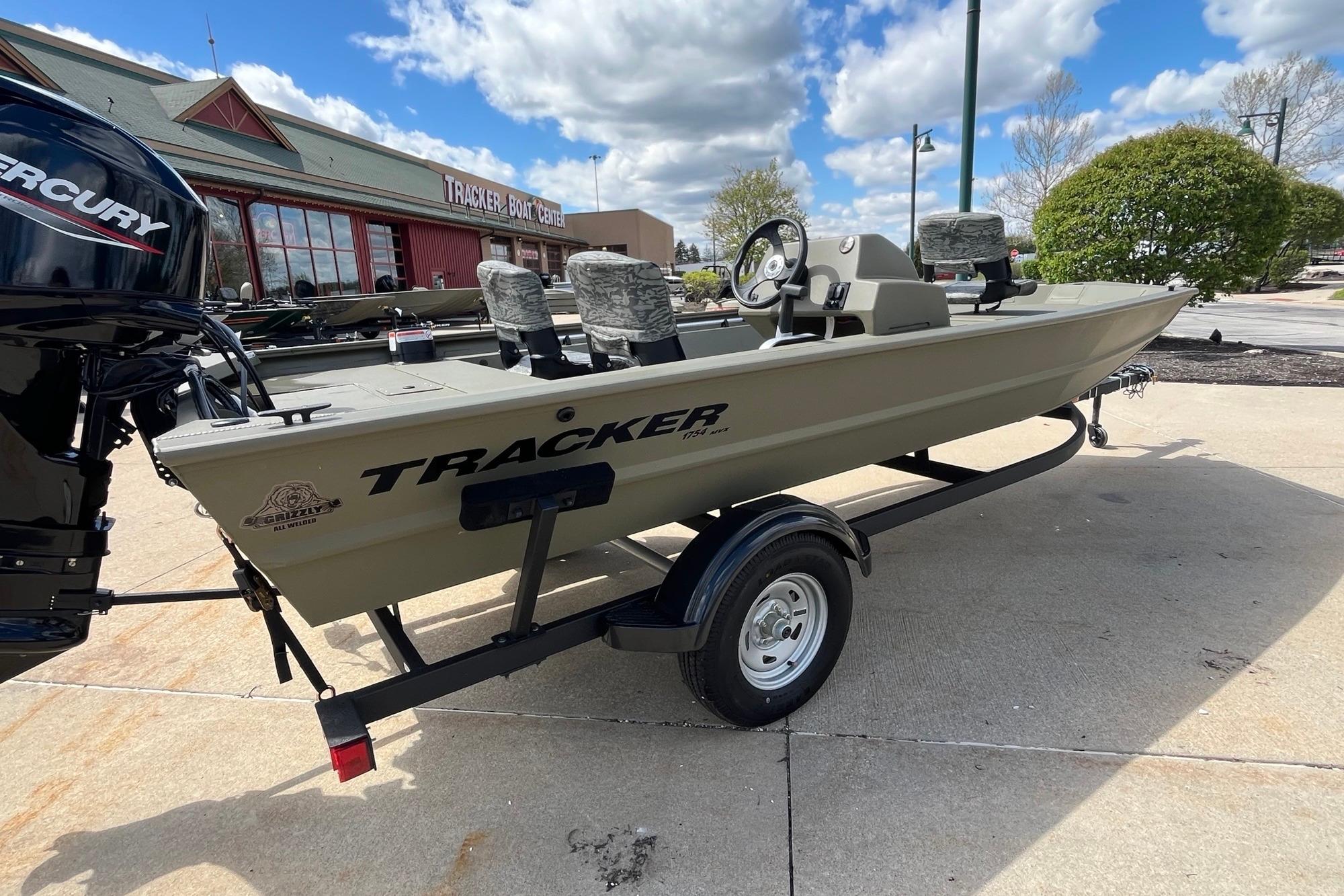 2026 Tracker Grizzly 1754 SC boat on trailer, parked outside Tracker Boat Center.