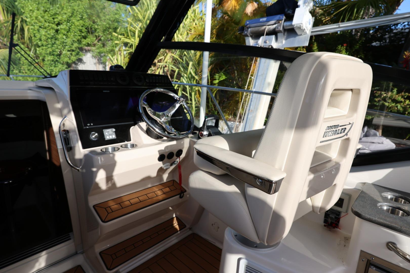 Helm of 2025 Boston Whaler 325 Conquest with modern controls and comfortable seating.