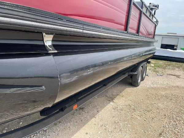 2023 Regency 250DL3 pontoon boat on trailer, featuring sleek black and red design.