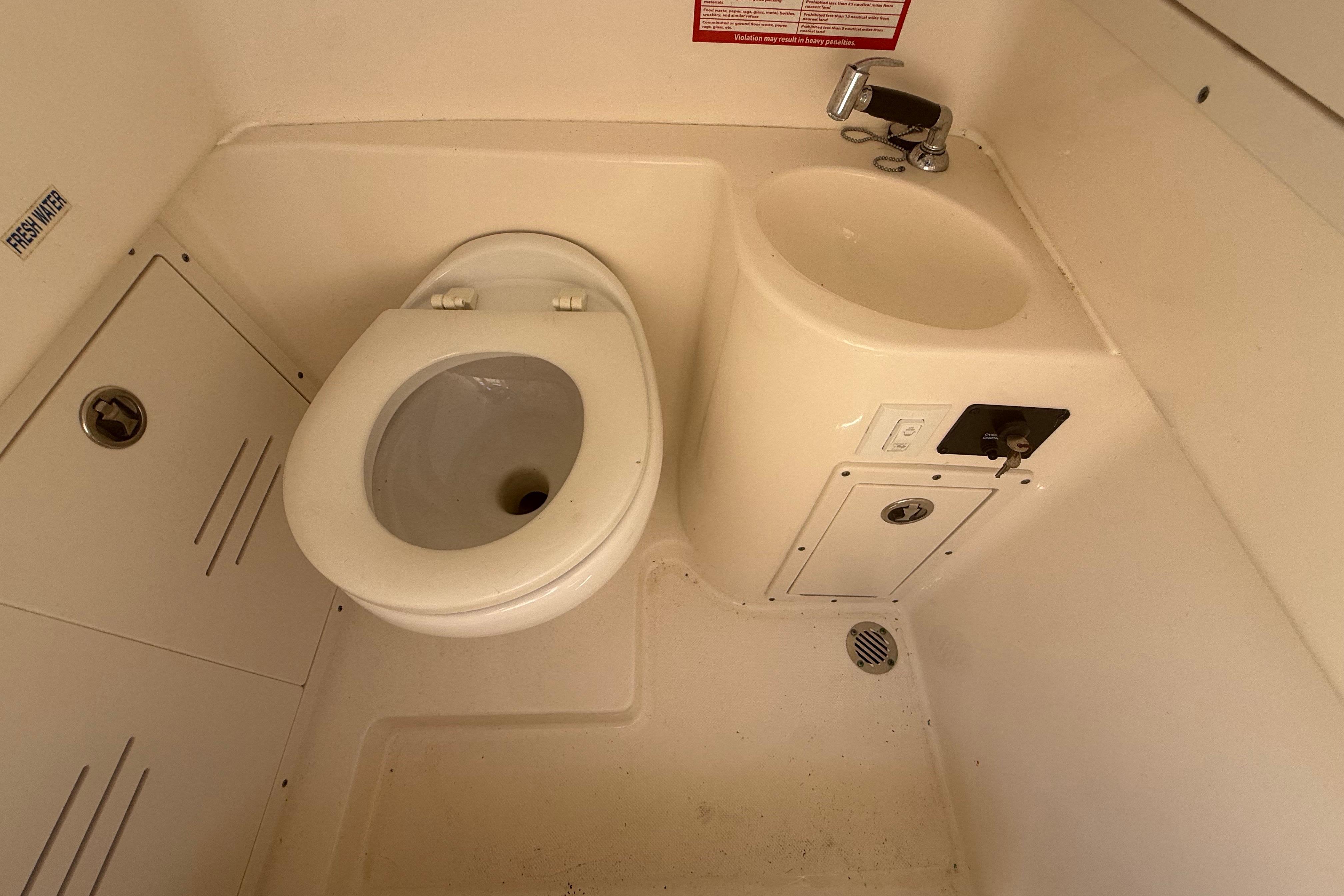 2019 Key West Billistic 281 Center Console boat bathroom with toilet and sink.