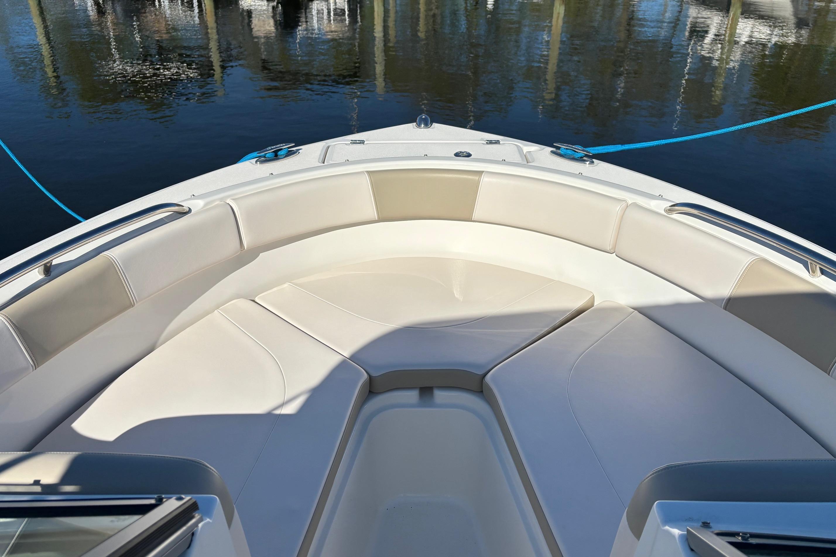 2017 Robalo R227 Dual Console boat with spacious bow seating, docked on calm water.