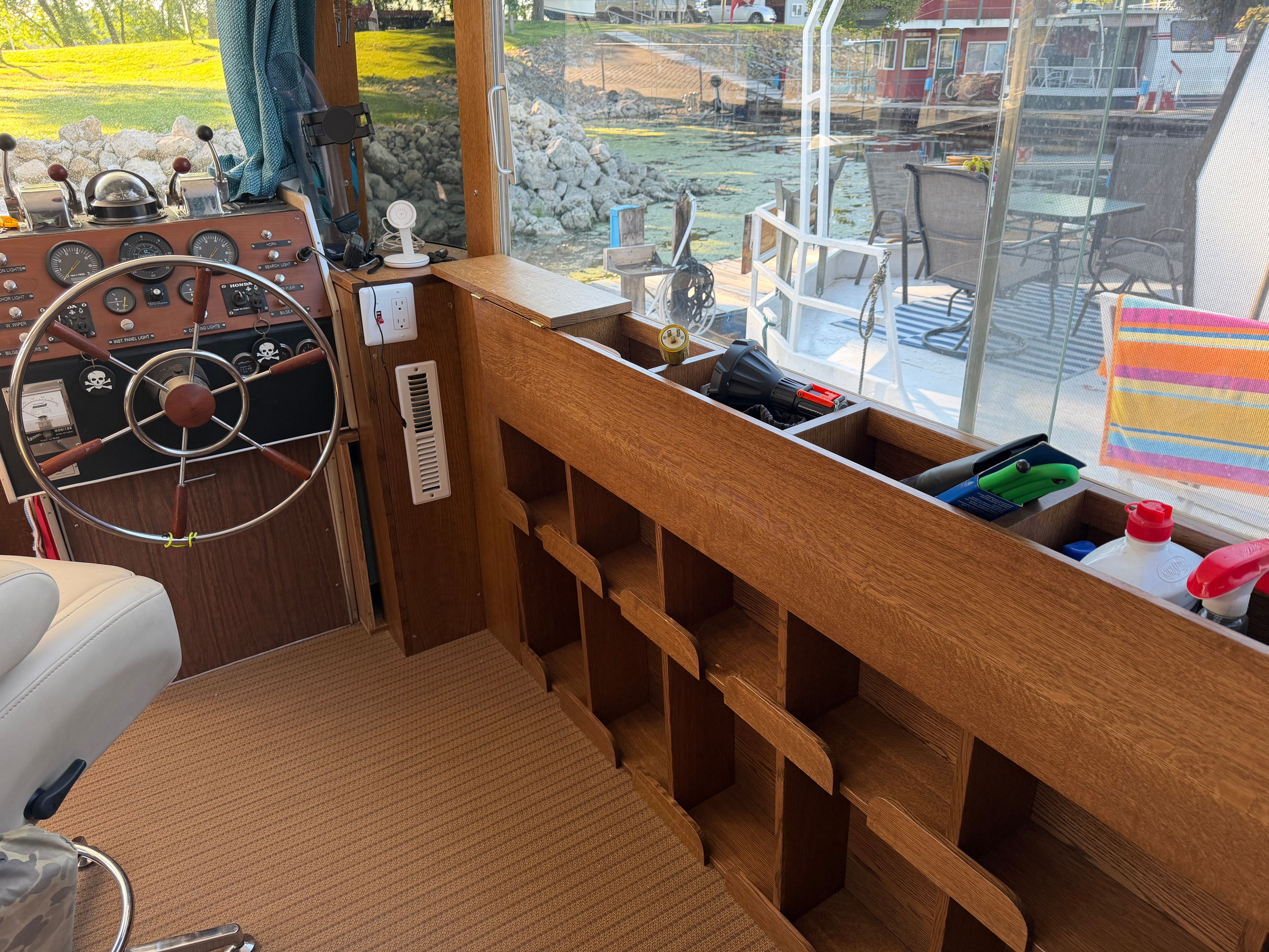 Interior of a 1972 Aluminum Cruiser Sea-Crest with steering wheel and storage space.