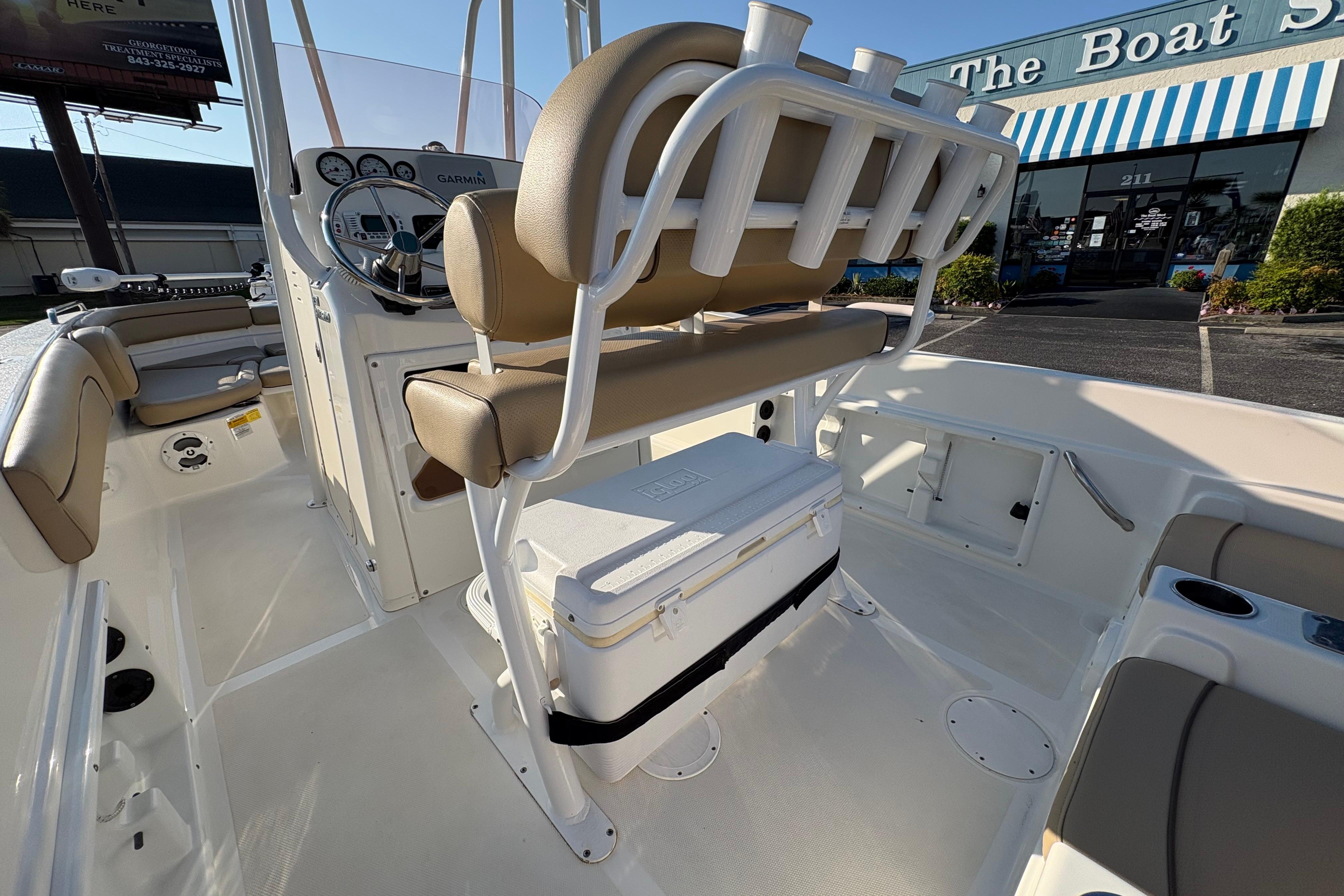 2019 NauticStar 231 Hybrid boat interior with seating and steering console.