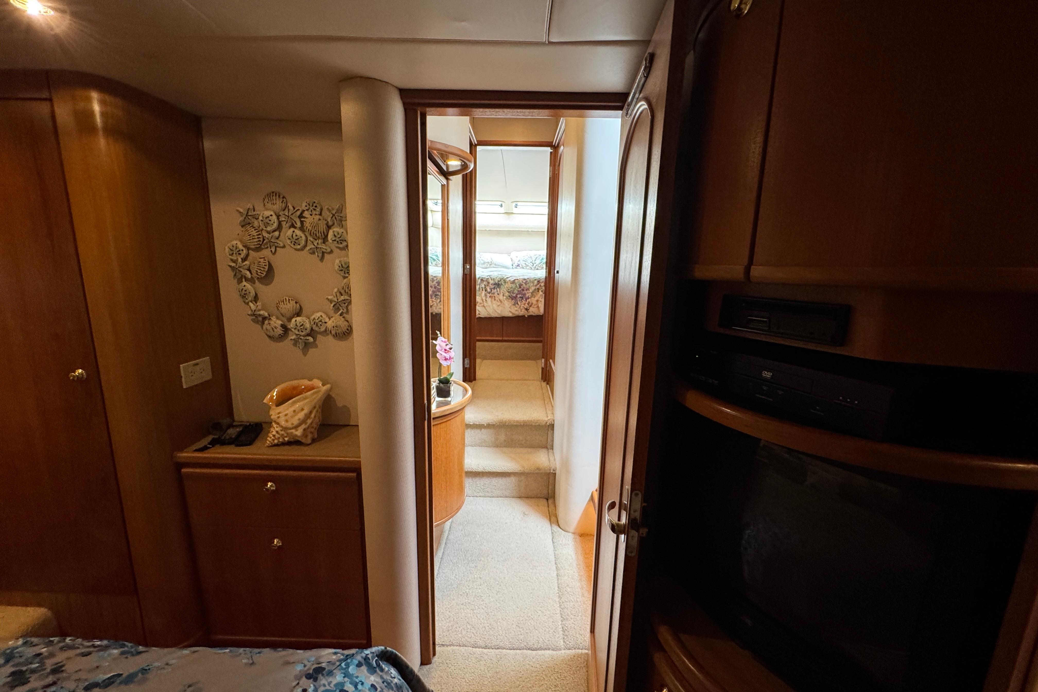 Interior of 1998 Bayliner 5788 Pilot House Motoryacht with wood cabinetry and cozy decor.
