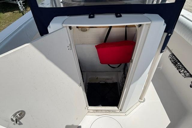 2011 Starcraft Star Step 229 CC OB boat storage compartment with open door and red life jacket.
