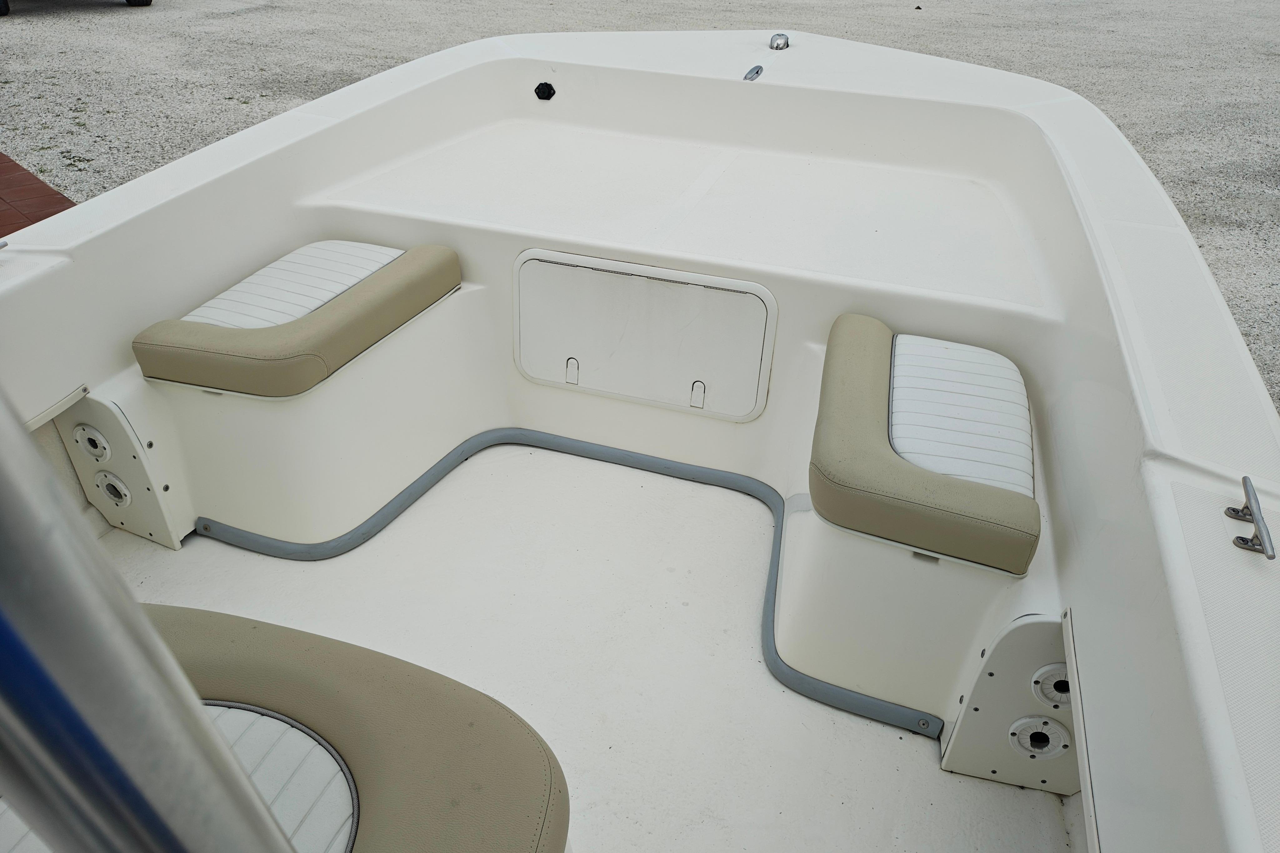 Interior of a 2018 Sundance B20CCR boat with cushioned seating and storage compartment.