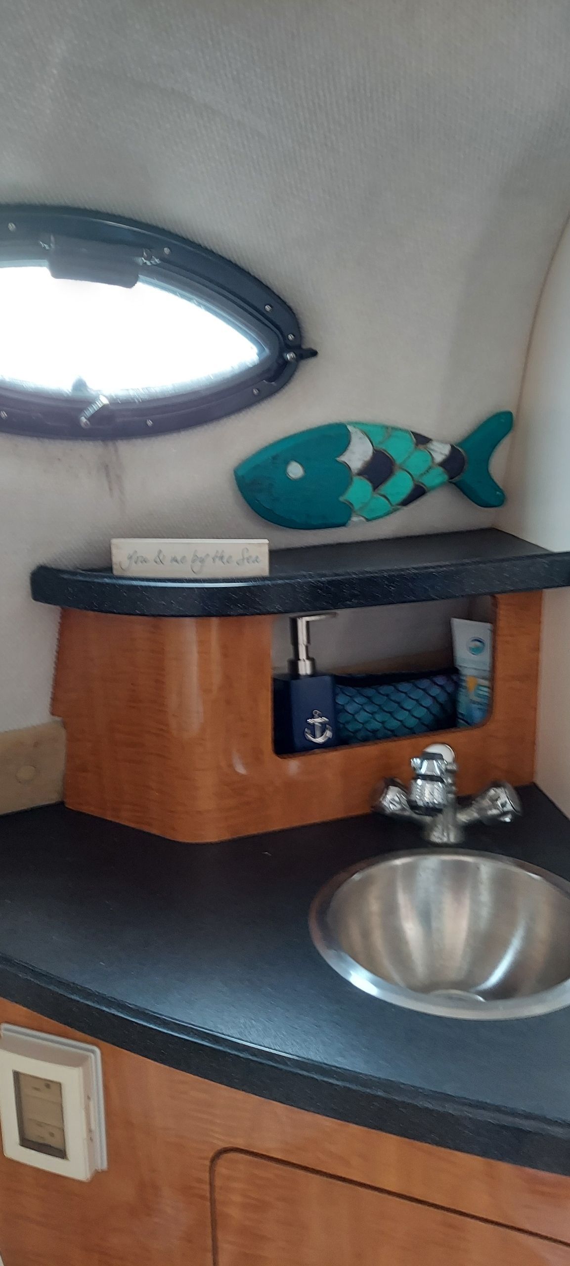 Interior of Regal Commodore 2465 yacht with sink and decor.