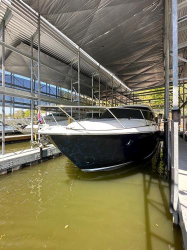 2019 Tiara Yachts C53 docked in a covered marina.