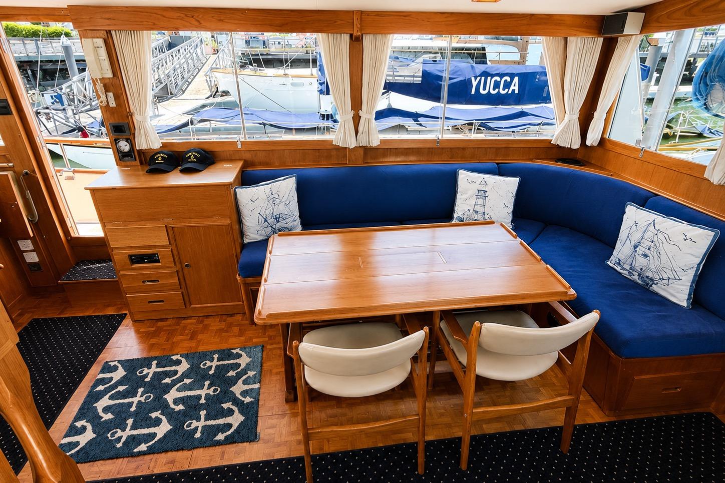 Interior of 1989 Grand Banks 42 Classic yacht with blue seating and nautical decor.