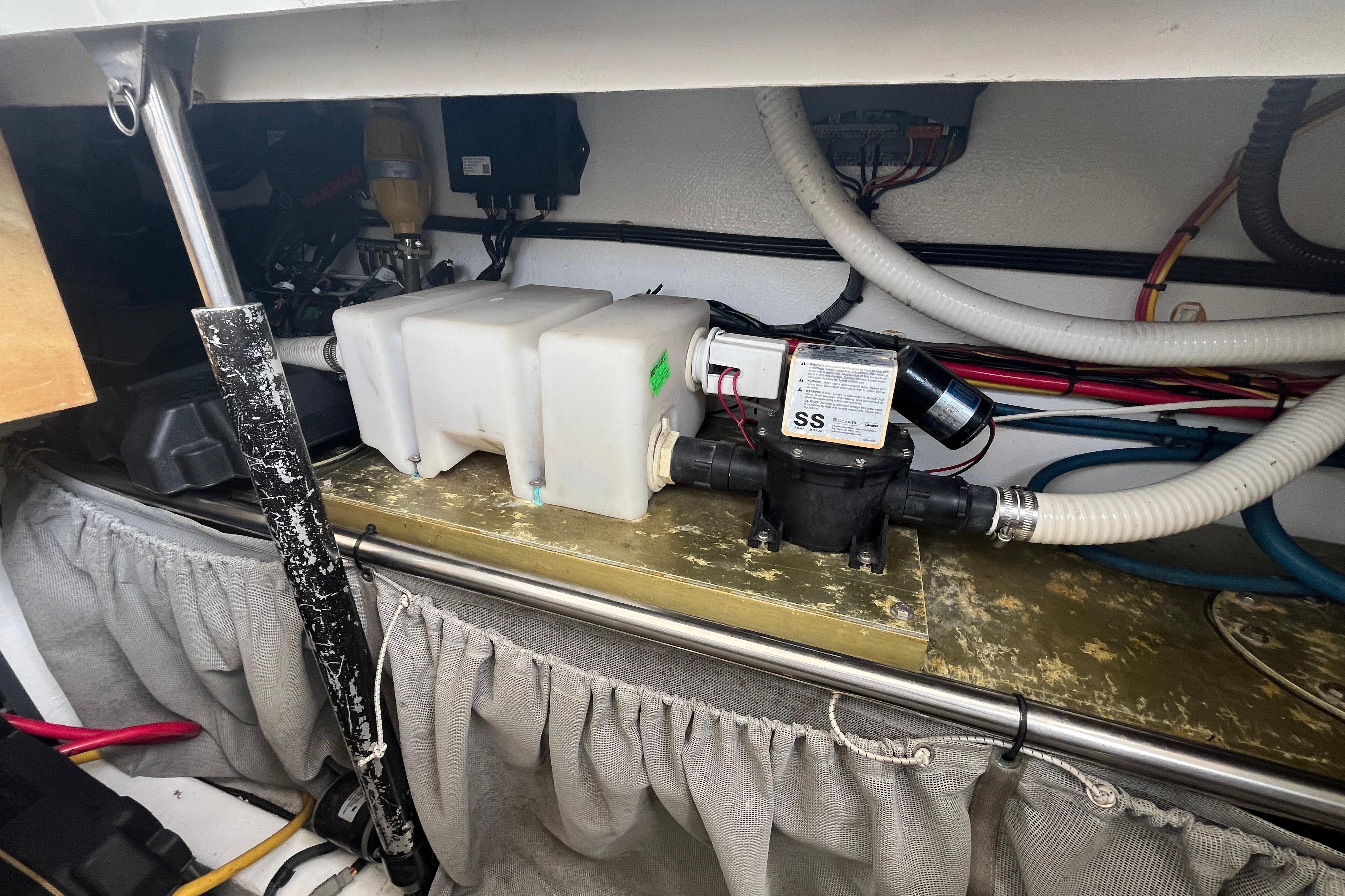 Engine compartment of a 2006 MJM 34z boat, featuring plumbing and wiring components.