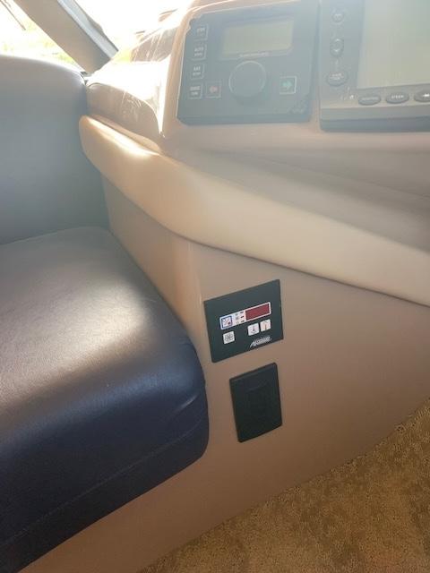 1999 Carver 450 Voyager interior dashboard with control panel and seating.