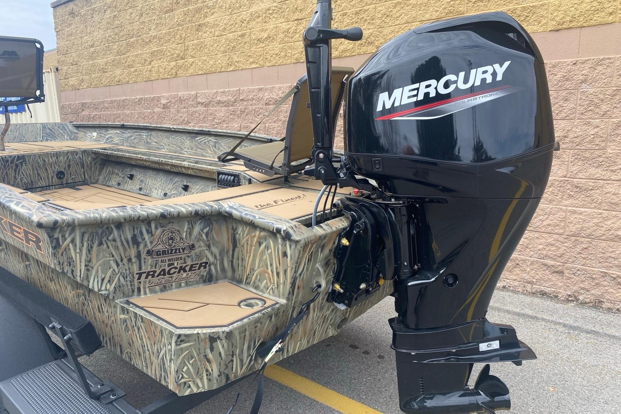 2026 Tracker Grizzly 1756 T Marsh boat with Mercury outboard motor, camo design.