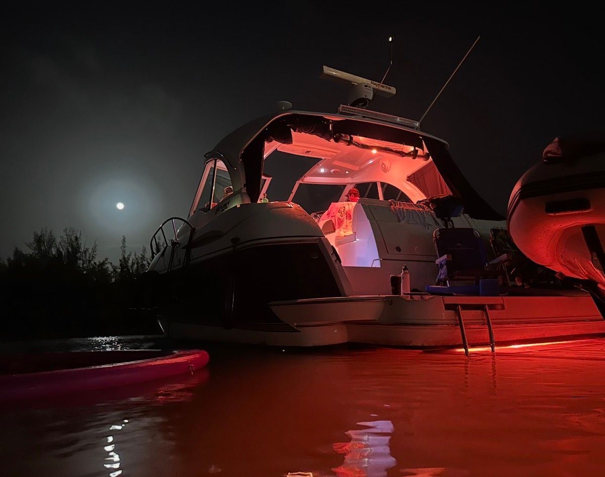 2012 Cruisers Yachts 430 Sports Coupe at night with red lighting.
