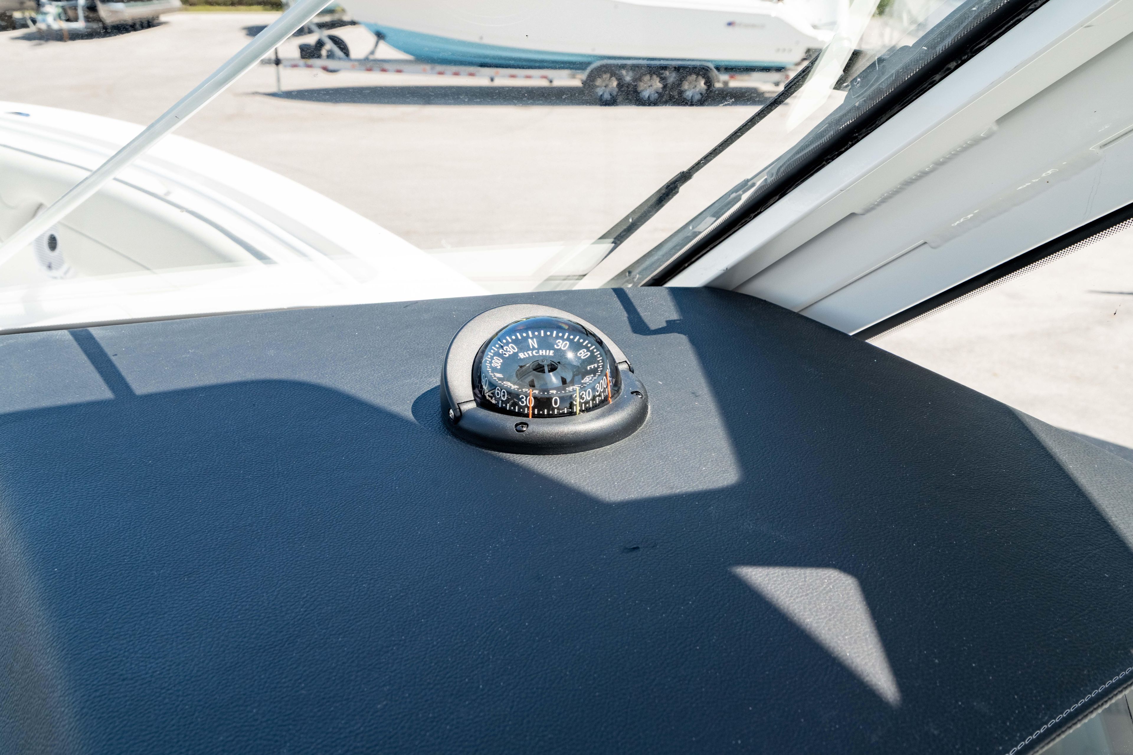 Compass on the dashboard of a 2026 Edgewater 262CX Crossover boat.