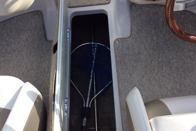 2012 Glastron GT180 boat interior with storage compartment and fishing net.