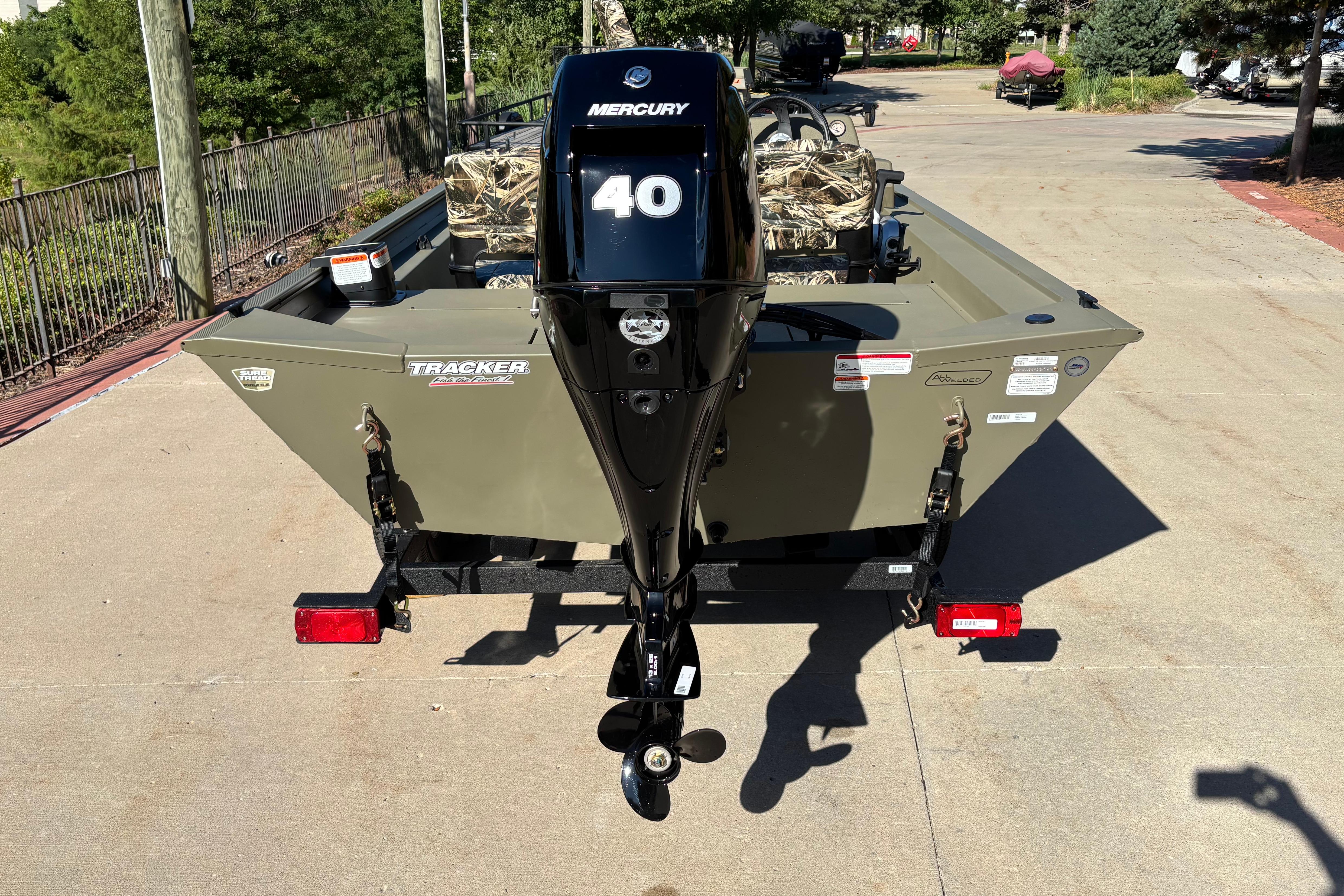 2026 Tracker Grizzly 1754 SC boat with Mercury 40 engine, parked outdoors.