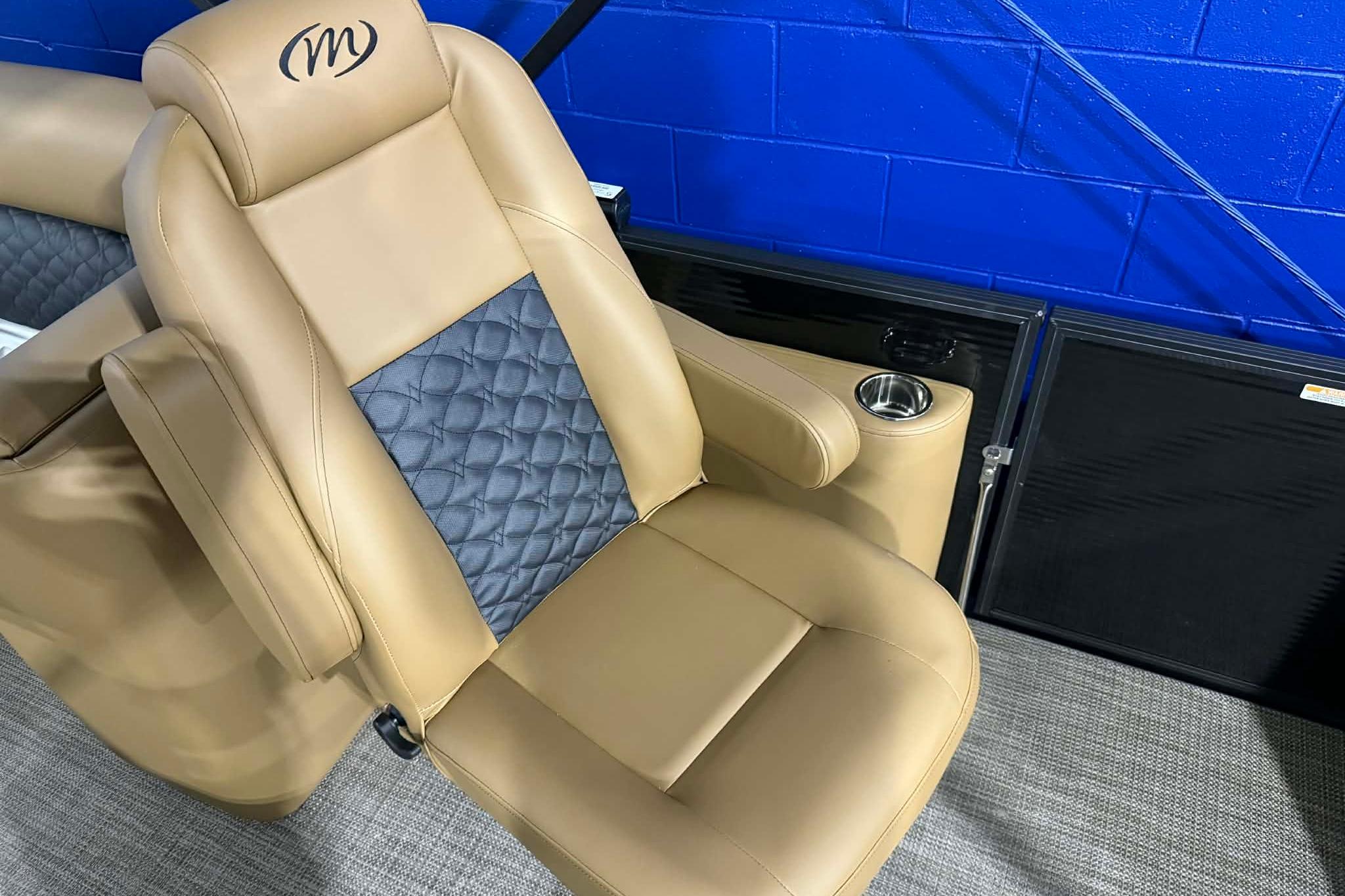 Luxurious tan seat of 2026 Manitou Encore VP 230 with cup holder and quilted design.