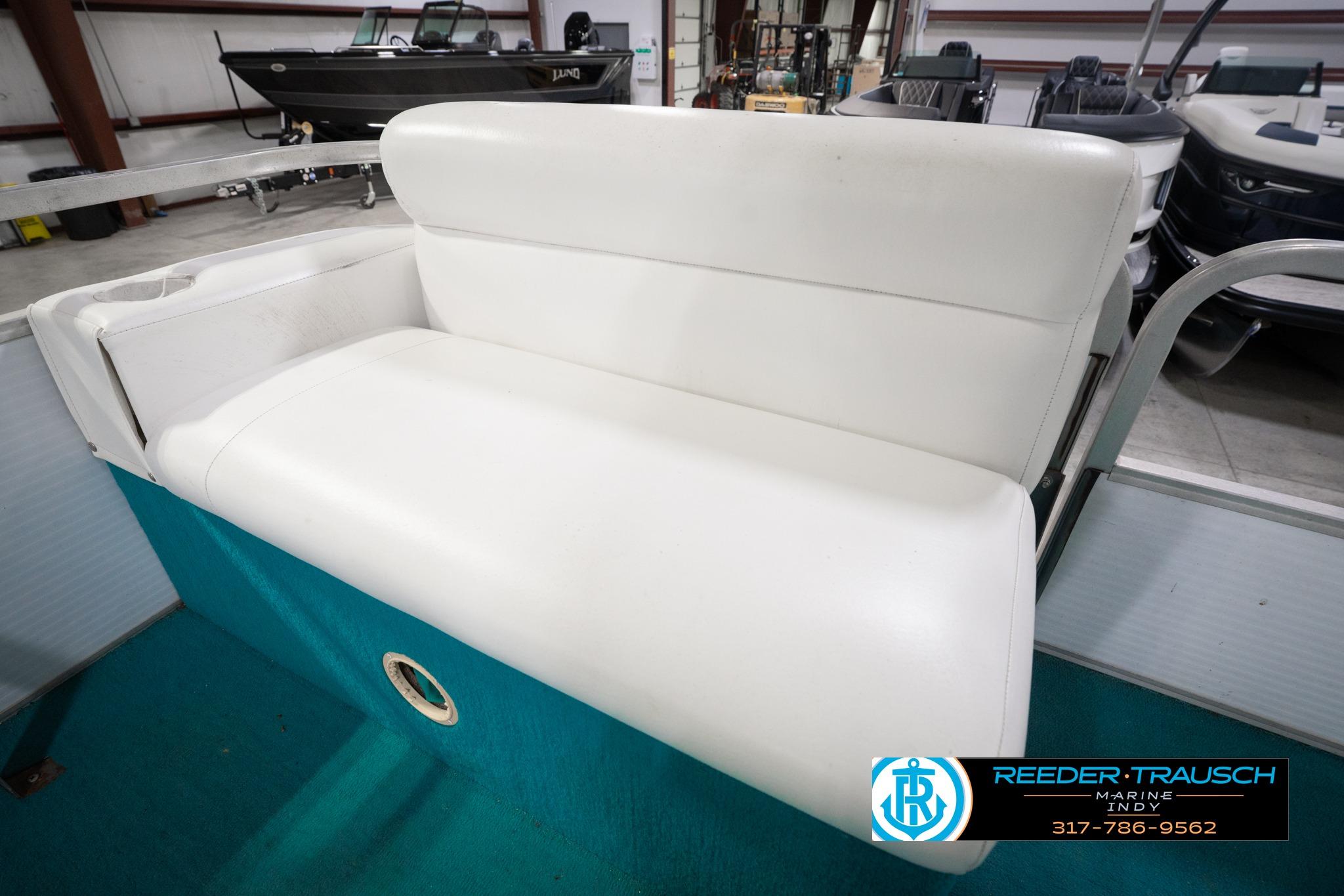 White seating on a 1992 Godfrey Sweetwater boat, displayed indoors.