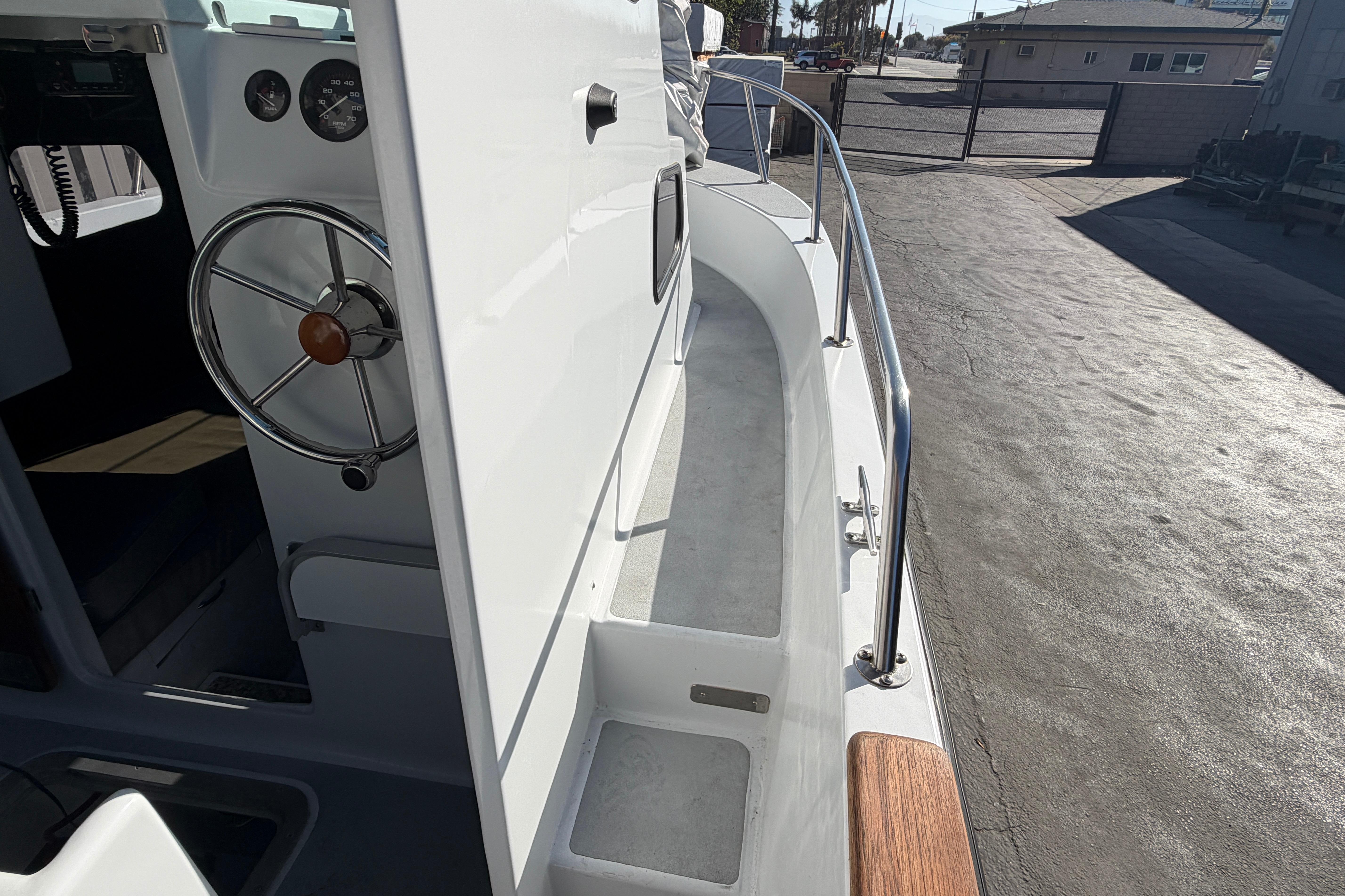 1986 Radon 21 Sport boat interior with steering wheel and deck view.