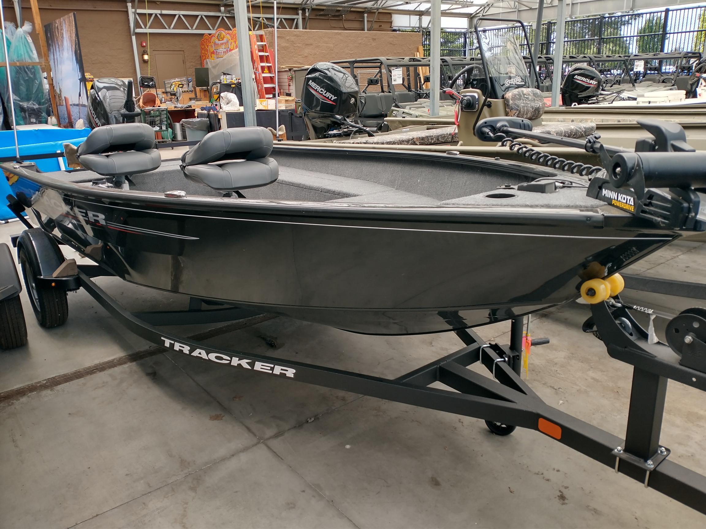 2025 Tracker Super Guide V-16 T fishing boat on display in showroom.