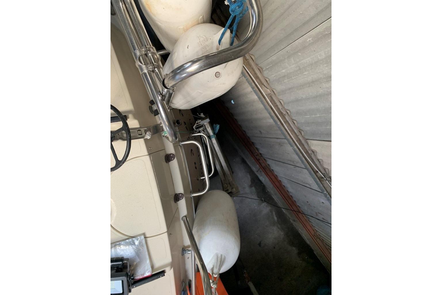 1980 Dehler Optima 98 sailboat interior with fenders and steering wheel visible.