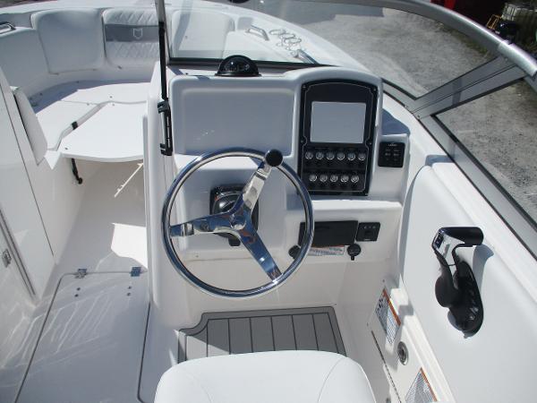 2025 Sea Fox 228 Traveler boat cockpit with steering wheel and control panel.