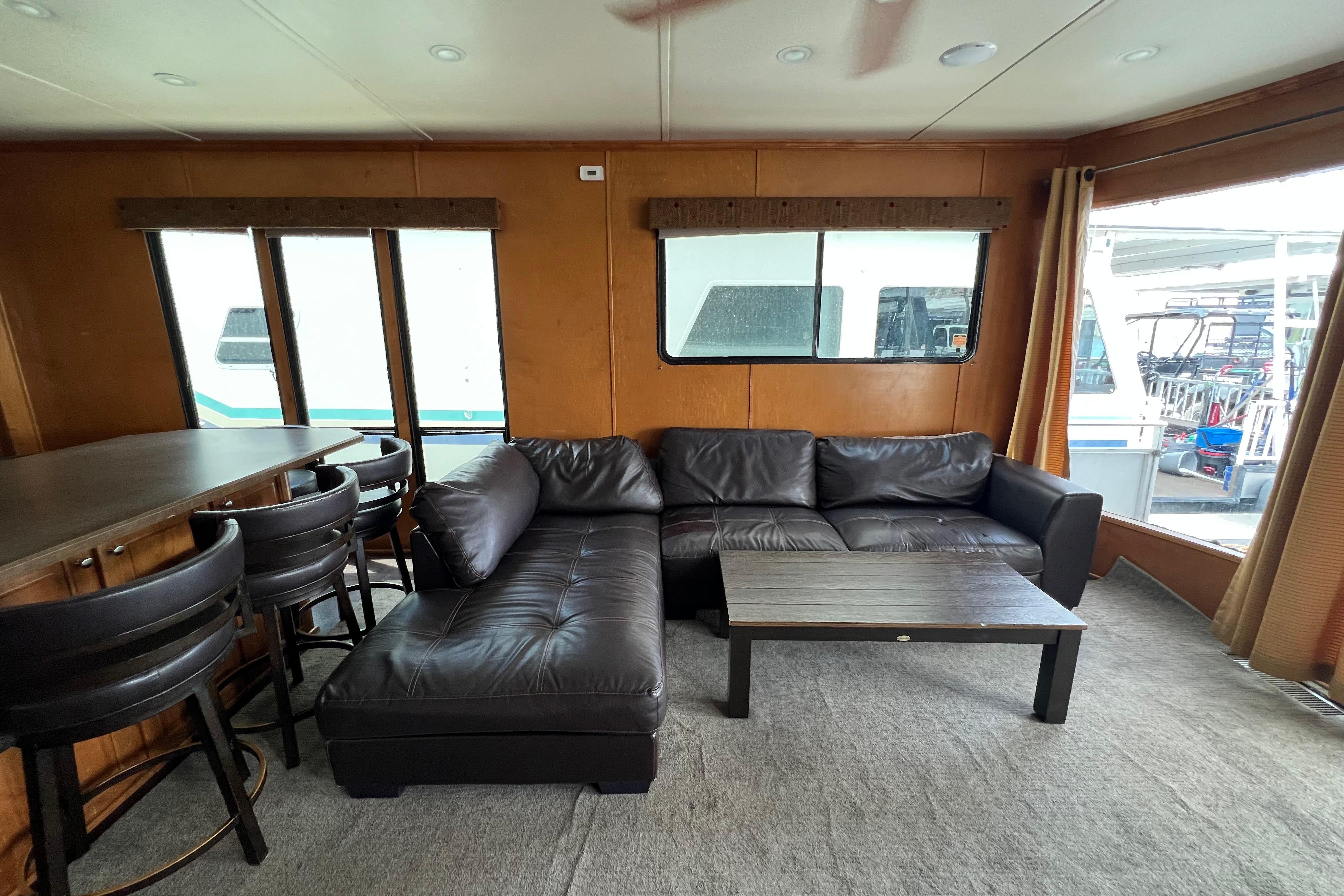 Interior of 2013 Destination Yacht Lotta Yachta with leather sofa and bar seating.
