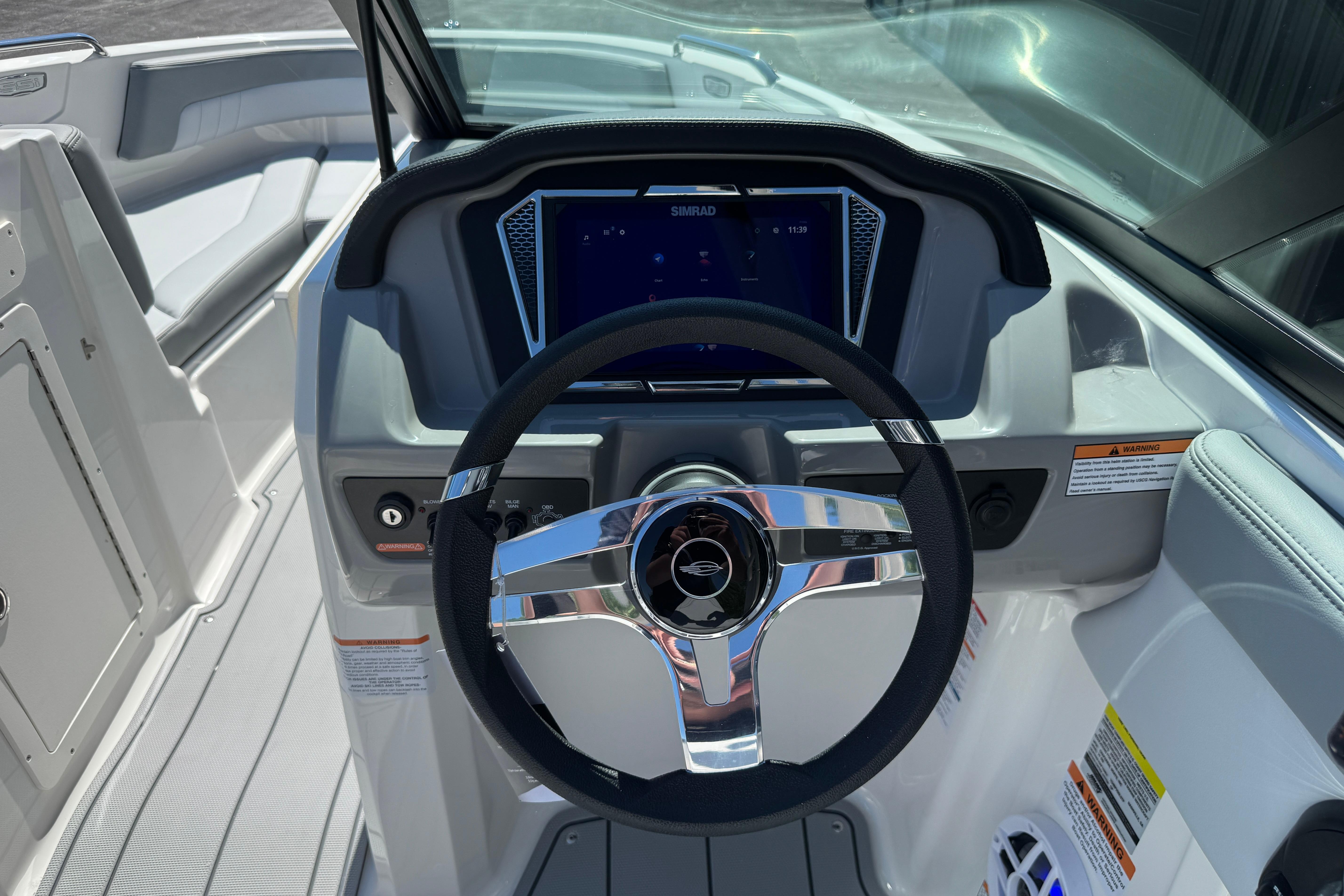 2026 Chaparral 21 SSi boat dashboard with steering wheel and digital display.