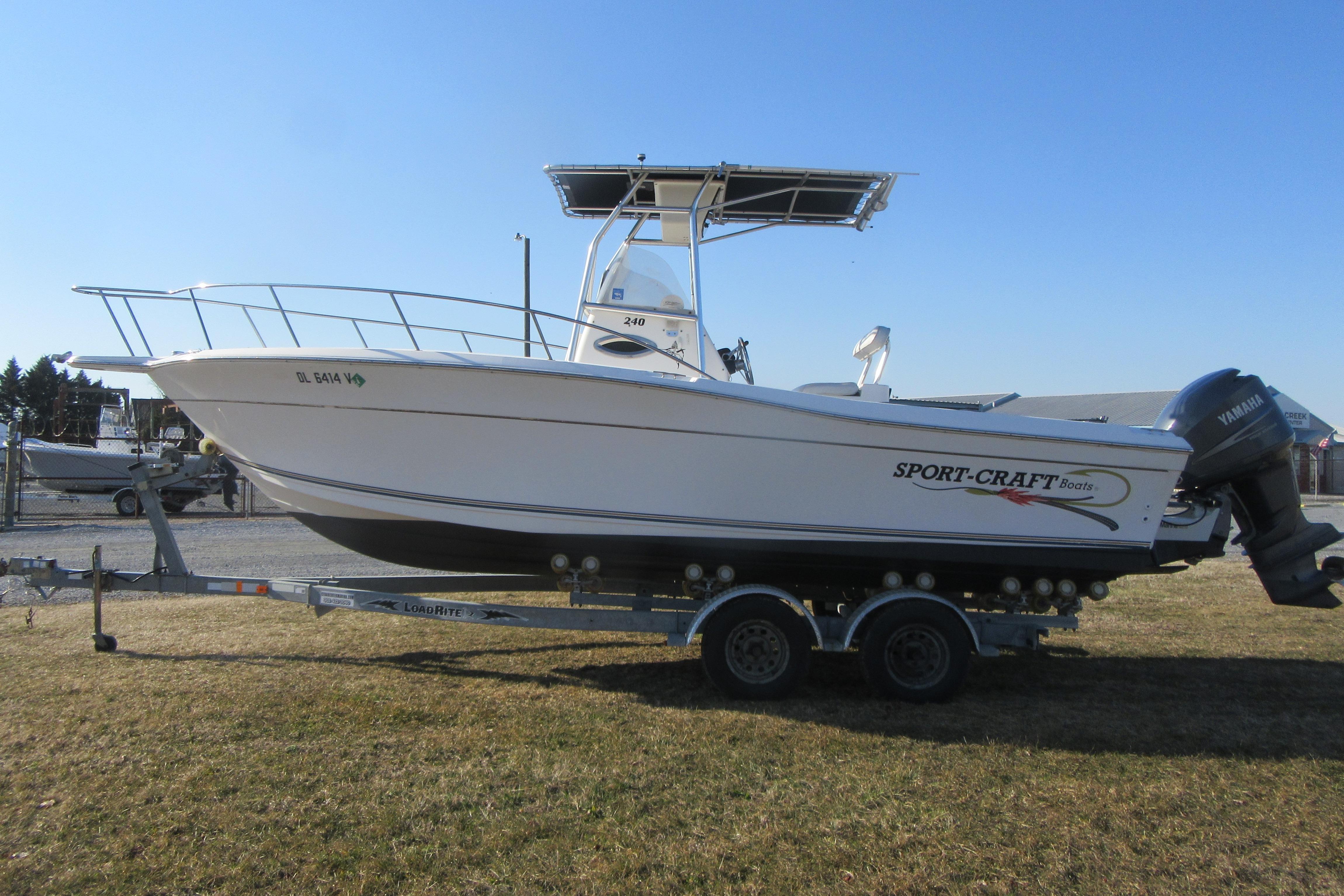2000 Sport-Craft 24 CC boat on trailer, side view, outdoors.