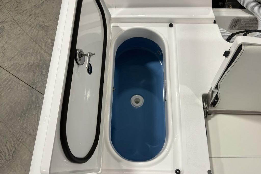 Livewell compartment on 2026 Tidewater 2300 Carolina Bay boat, featuring a blue interior.