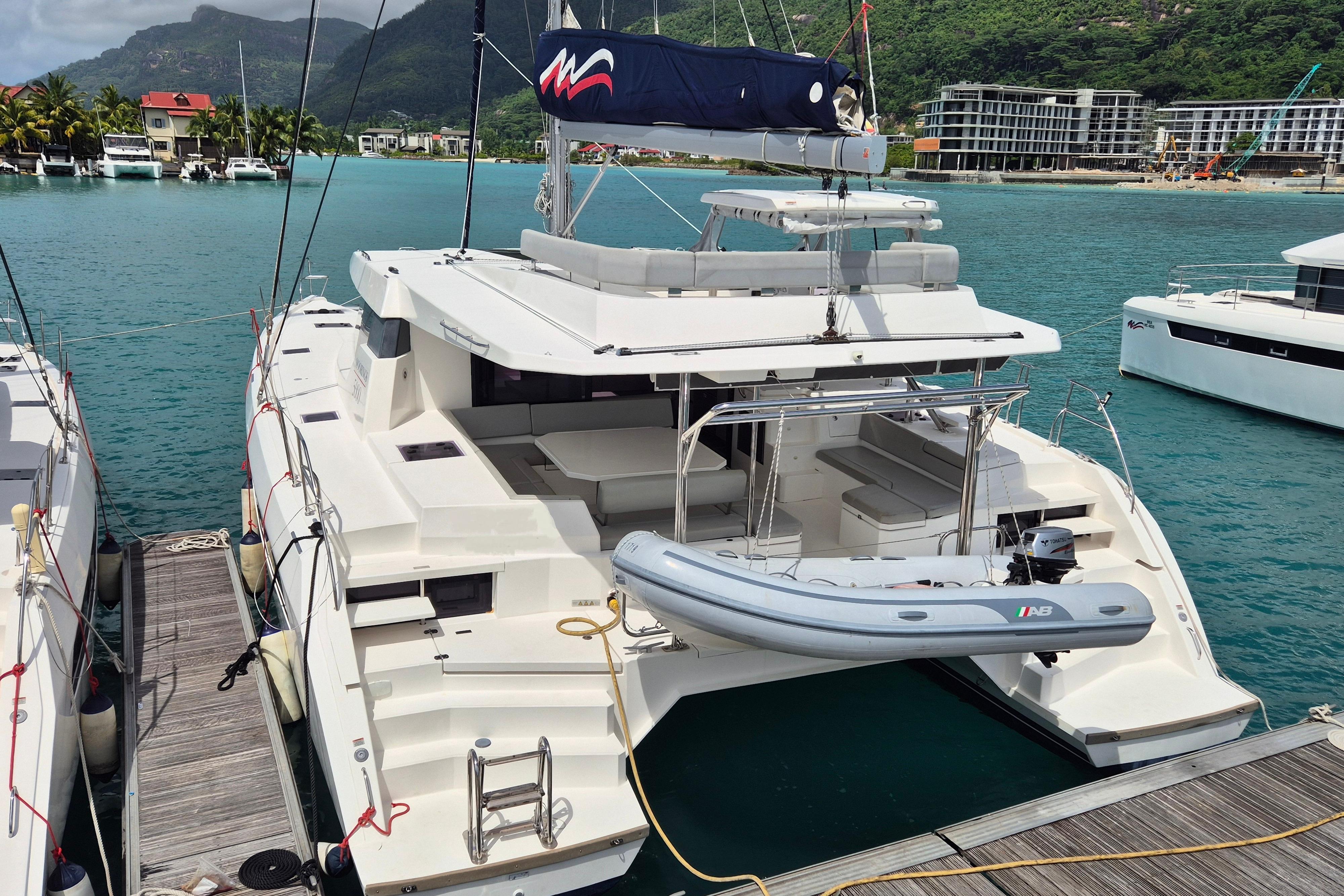 Luxury Leopard 50 catamaran docked in scenic marina, 2021 model.