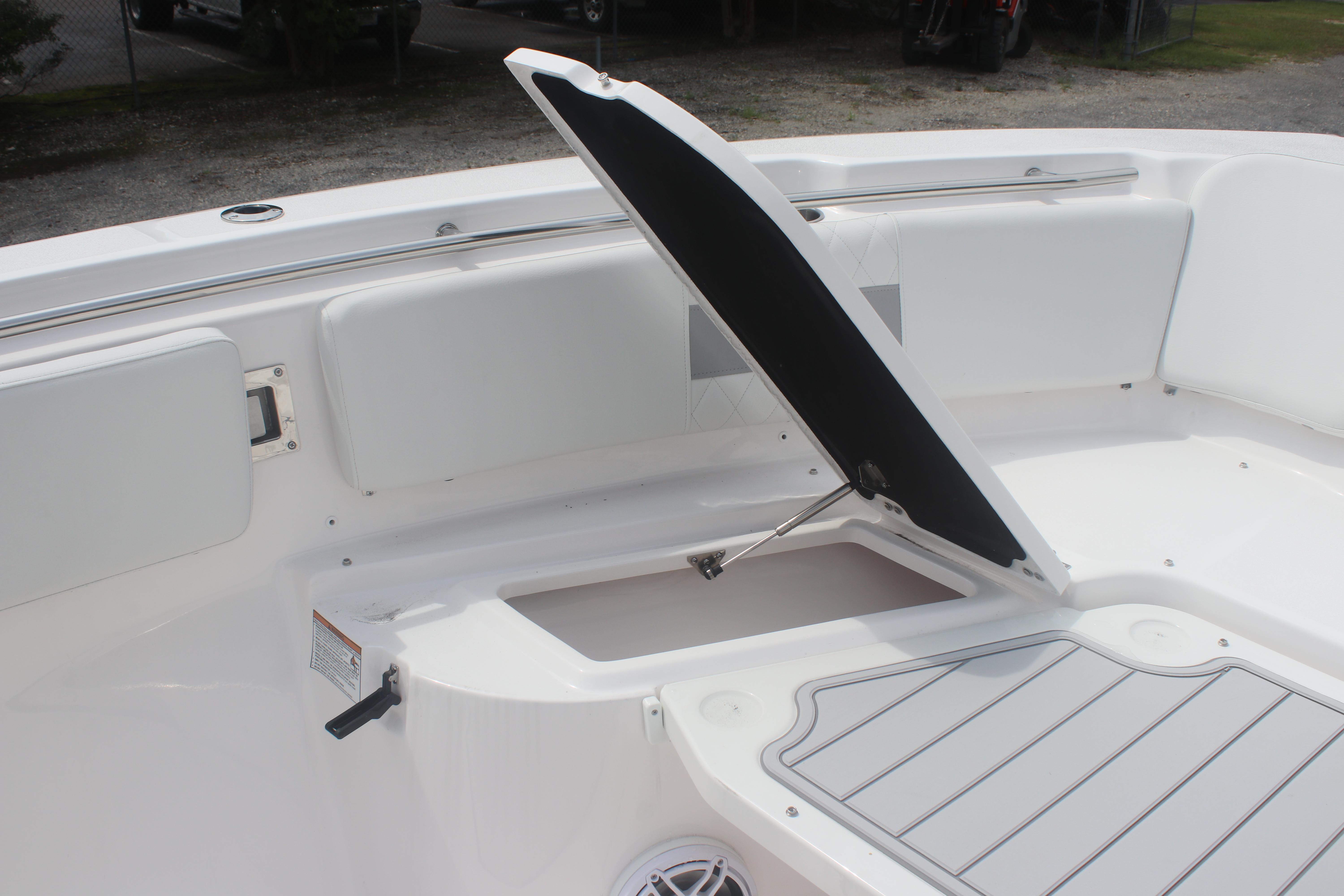 2026 Sea Fox 288 Commander boat with open storage compartment and cushioned seating.