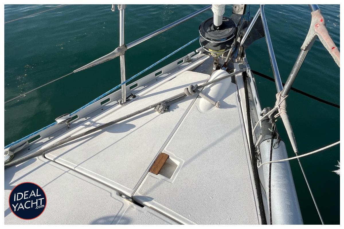Deck view of a 1998 Dufour 50 Classic yacht, featuring rigging and calm waters.