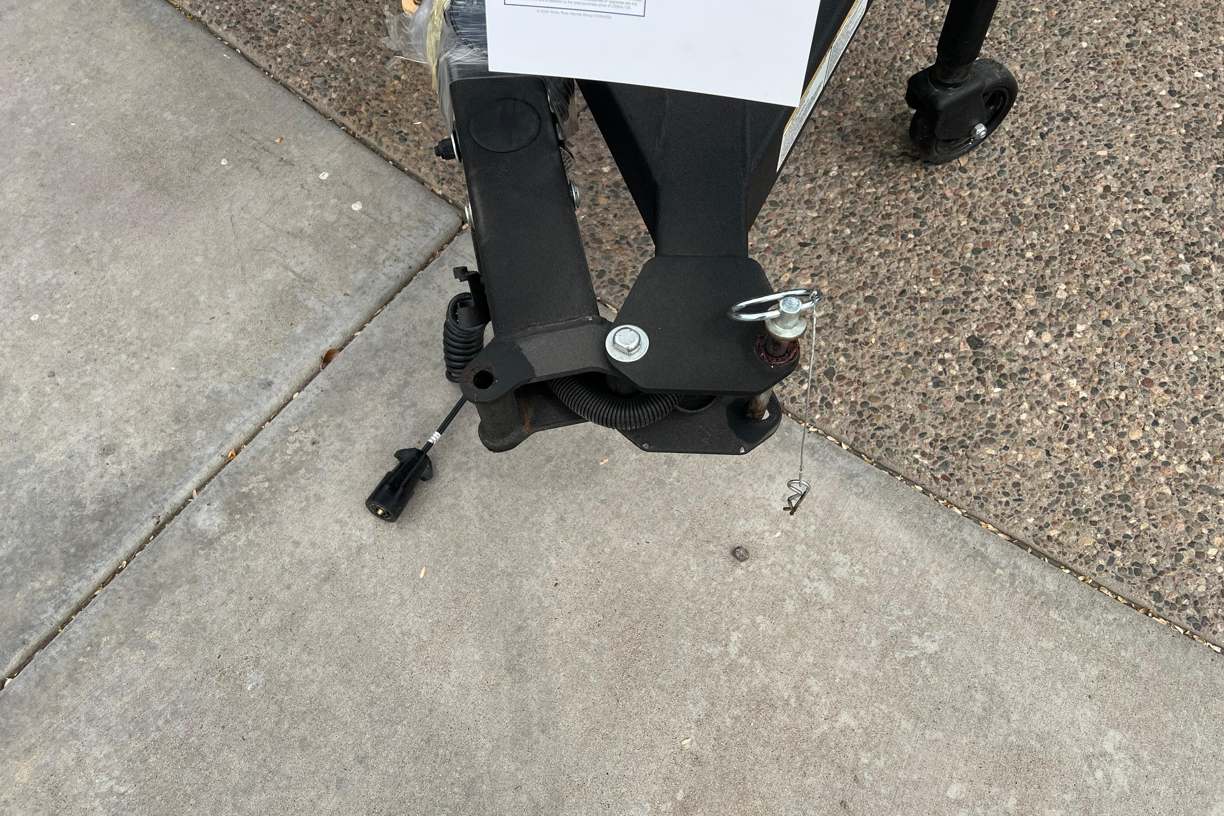 Trailer hitch of 2026 Ranger VS1682SC Angler on concrete and gravel surface.