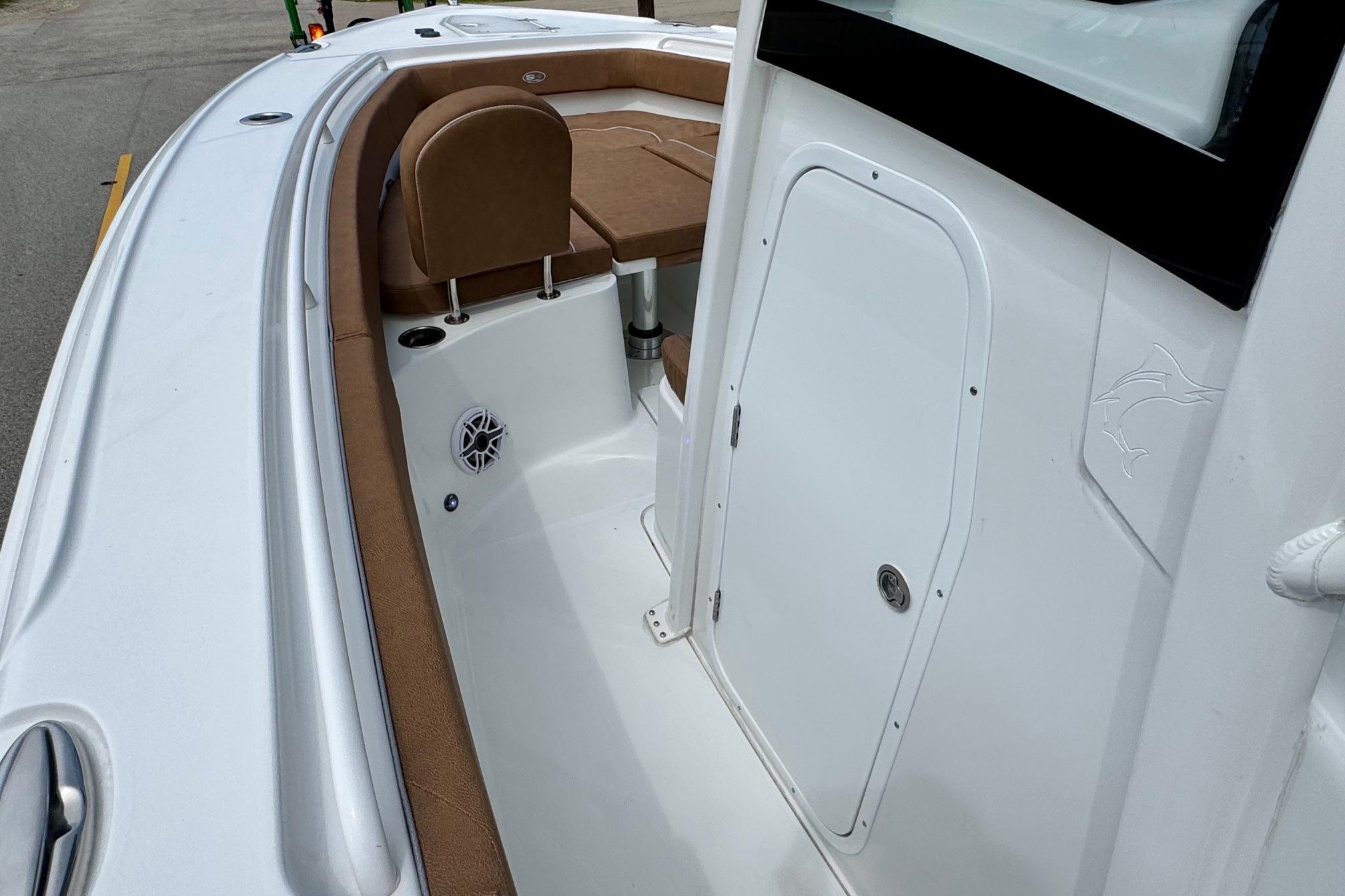 2026 Sea Hunt Ultra 275 SE boat interior with brown seating and white deck.