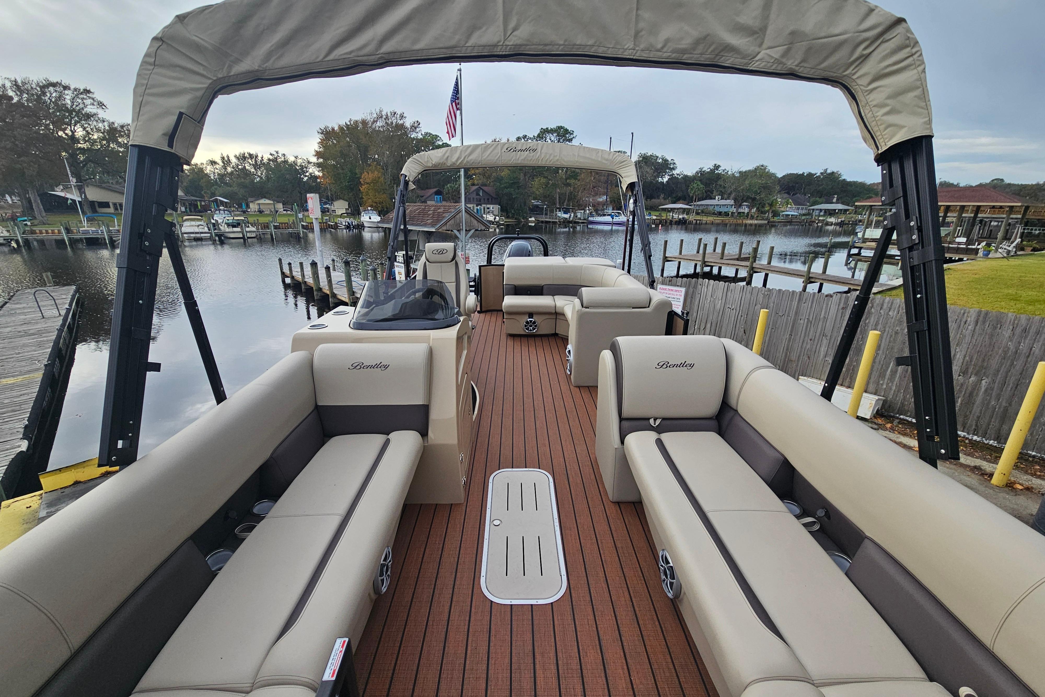 2026 Bentley Pontoons Legacy 243 Cruise on a serene waterfront dock.