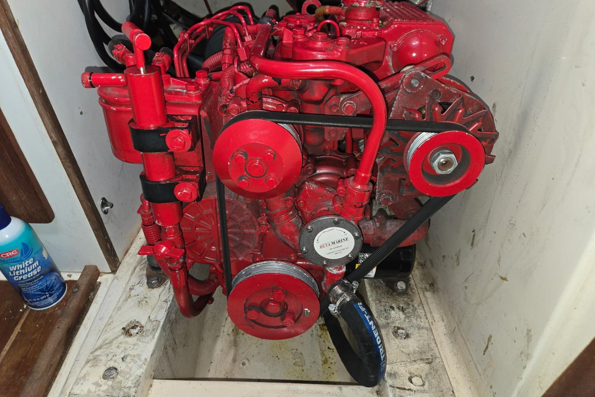 Red marine engine in a 1981 Sea Sprite 34 sailboat compartment.