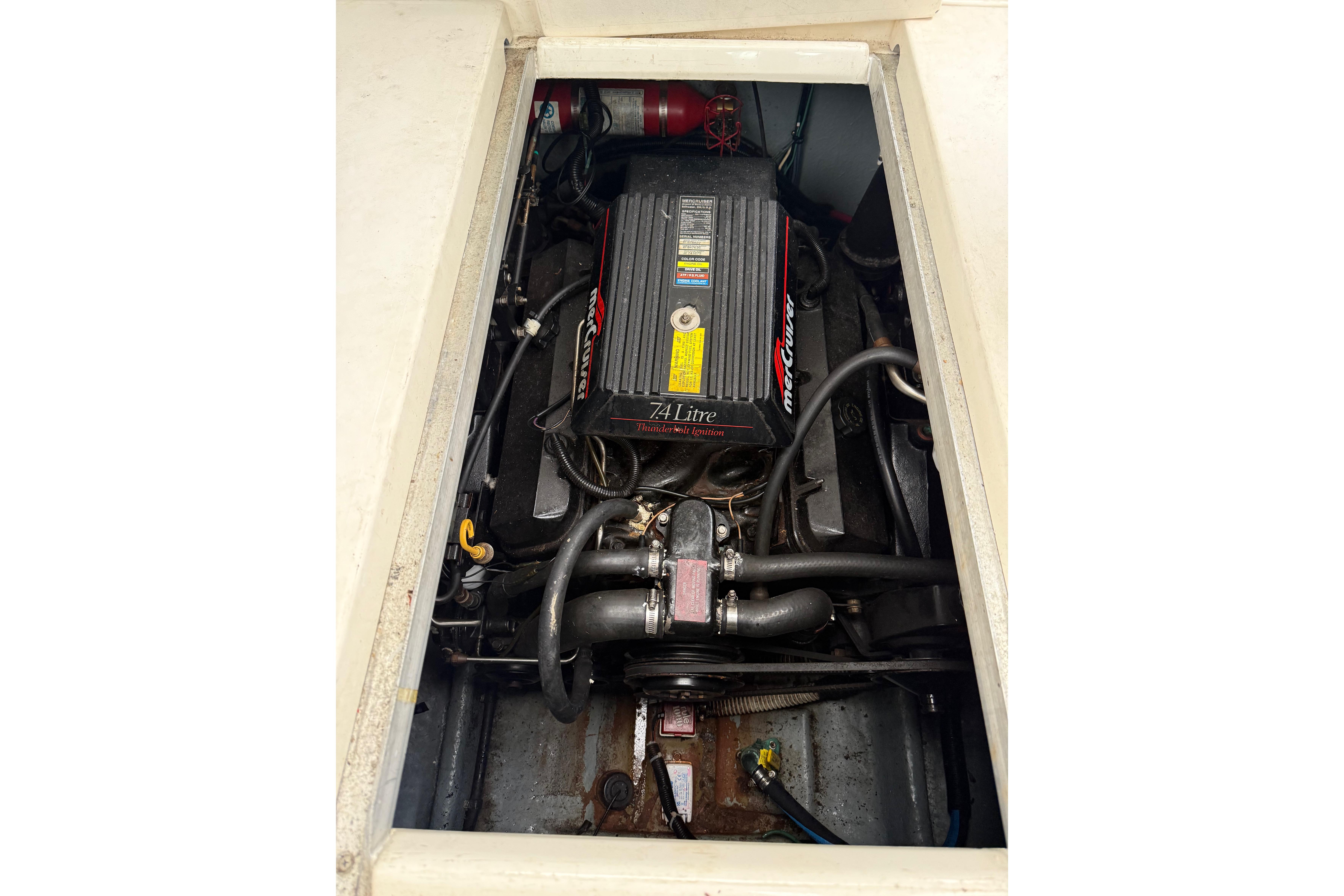 Engine compartment of a 1996 Sea Ray 270 Sundancer boat, featuring a 7.4L MerCruiser engine.