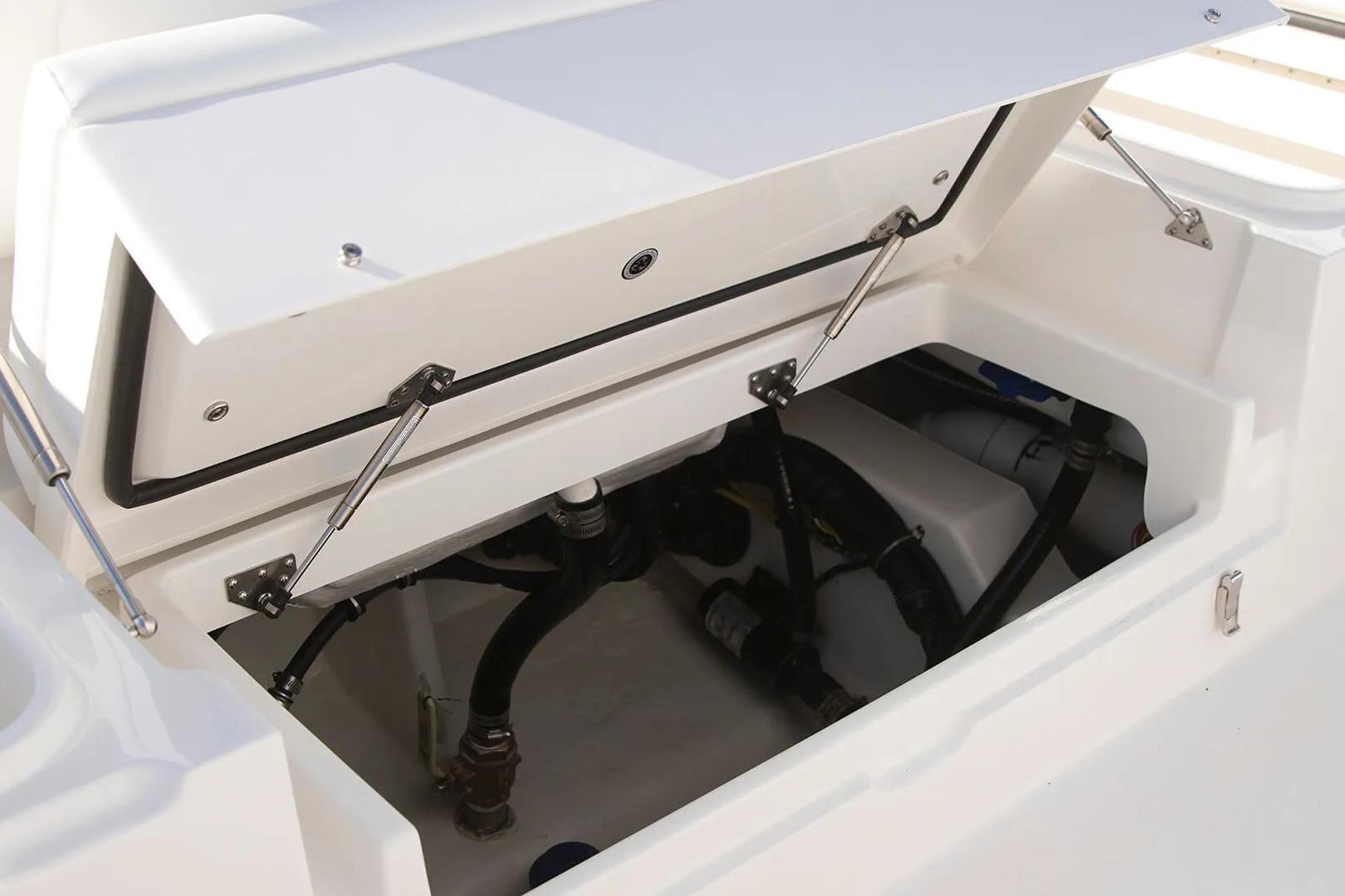 Open storage compartment on 2027 Regulator 24XO boat, showcasing internal components and wiring.