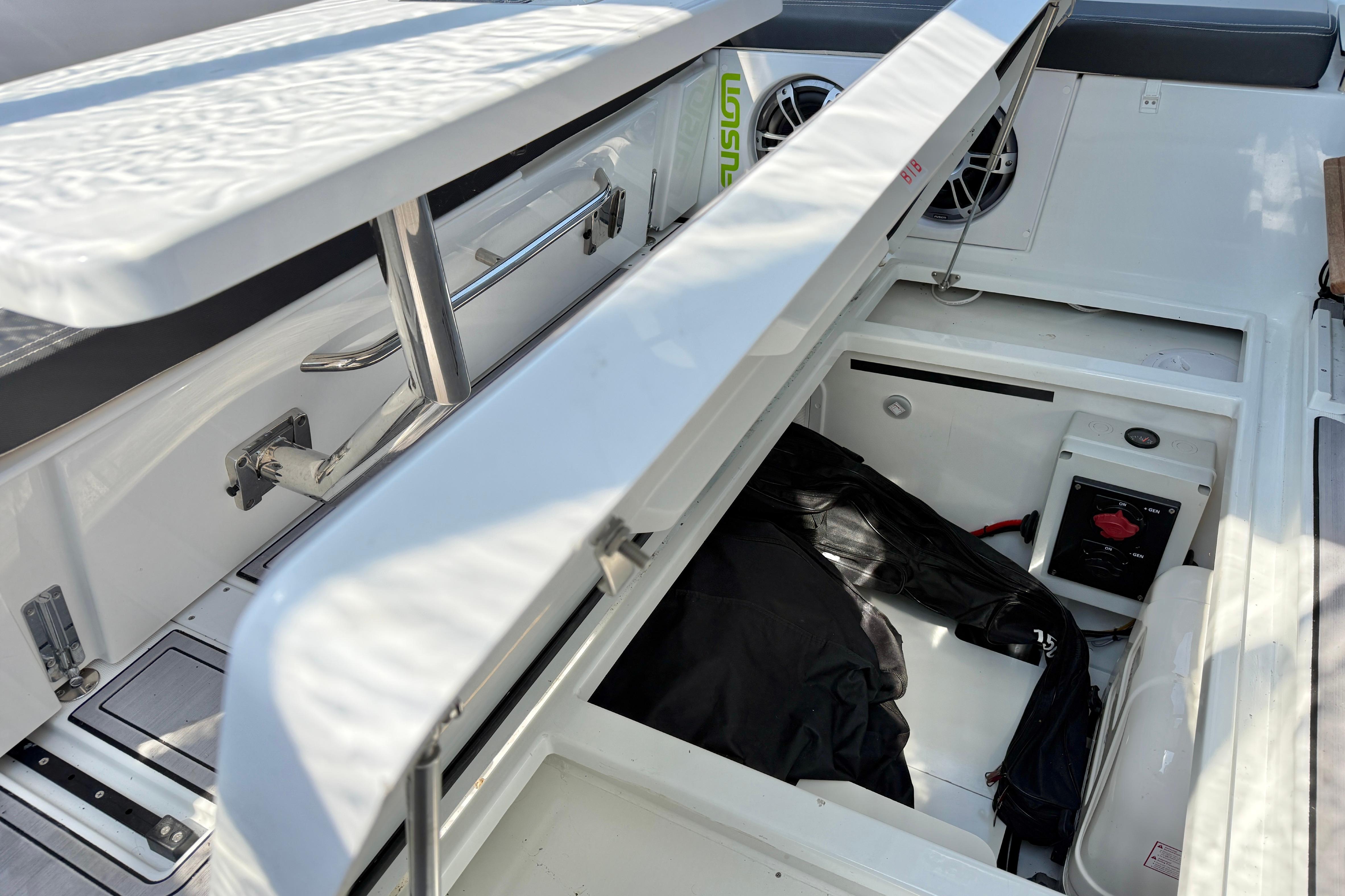 2022 Jeanneau NC 1095 Fly boat storage compartment with open hatch and visible equipment.