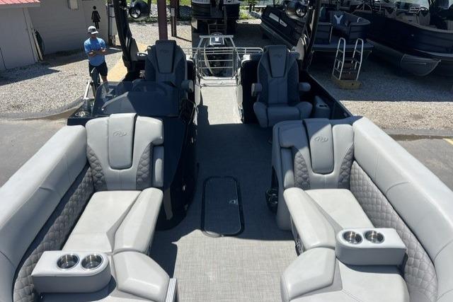 2024 Manitou 25 LX SRW pontoon boat interior with luxurious gray seating and cup holders.