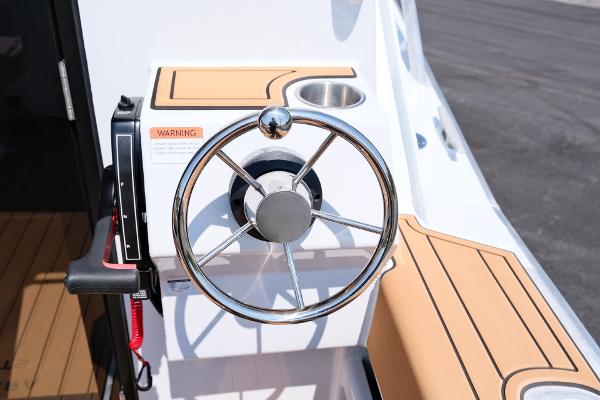Steering wheel of 2023 Makaira Gen3 800 boat with modern design and controls.