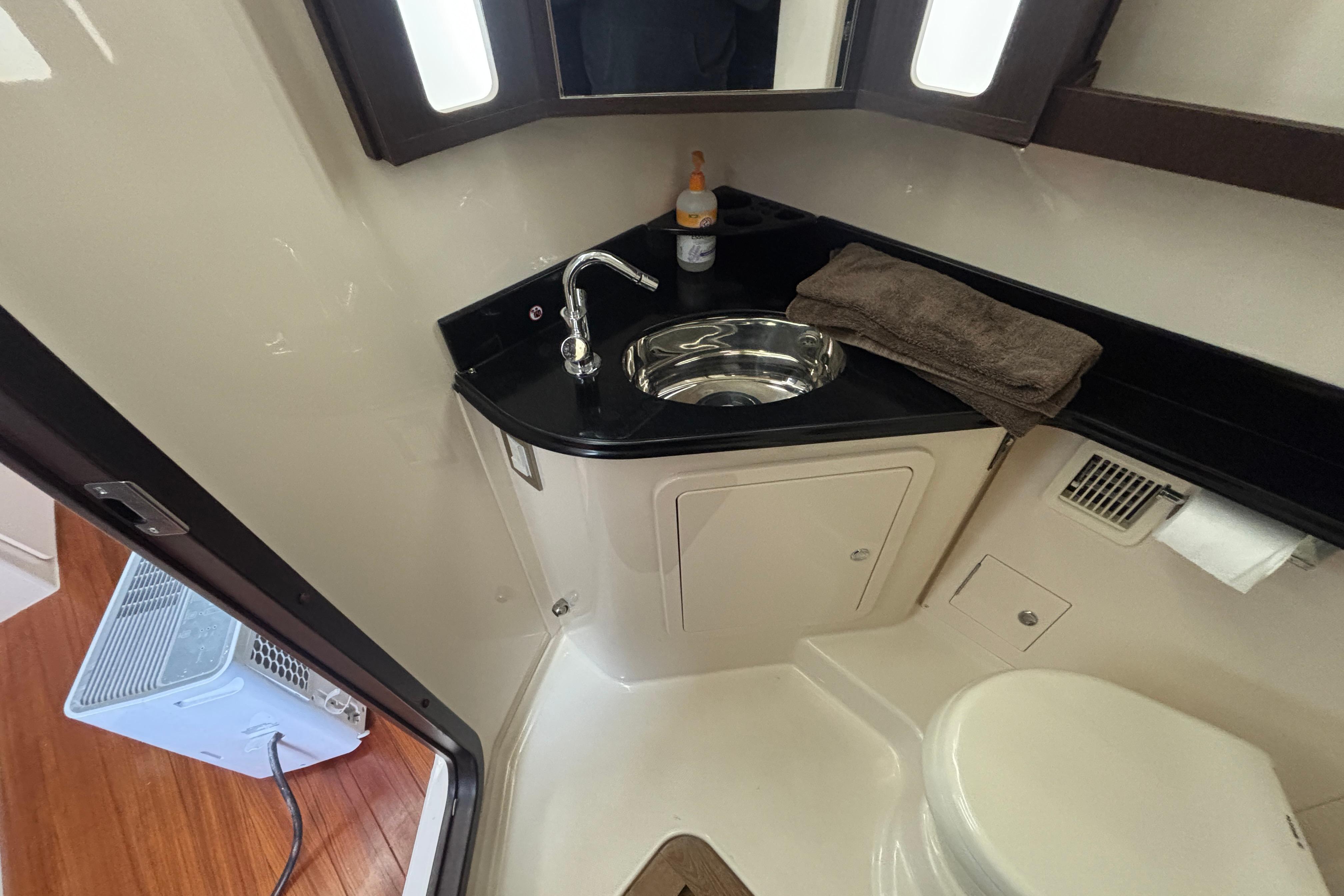 2019 Grady-White Canyon 456 boat bathroom with sink, towel, and toilet.