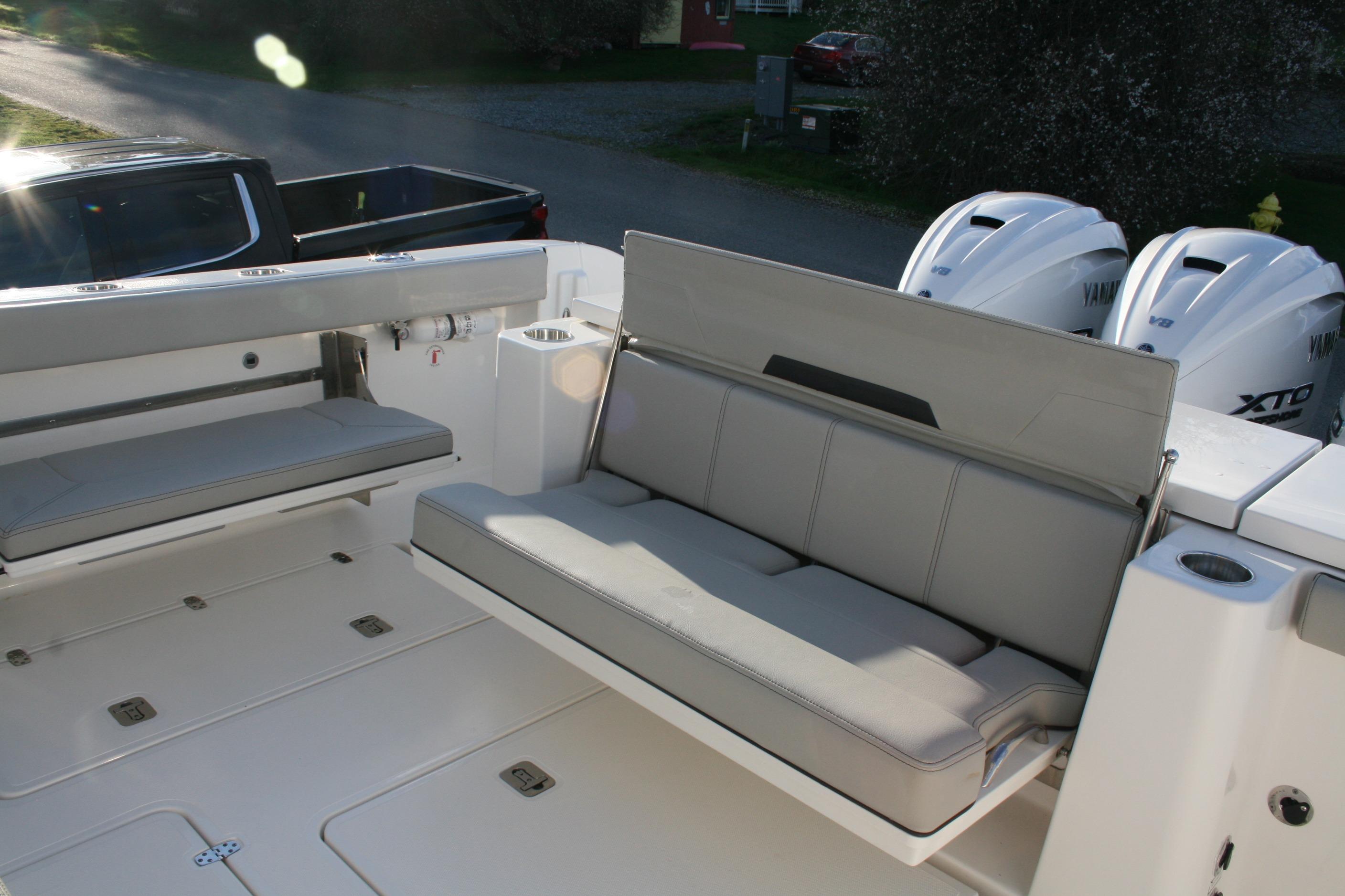 2025 Pursuit OS 405 Offshore boat with cushioned seating and Yamaha engines.
