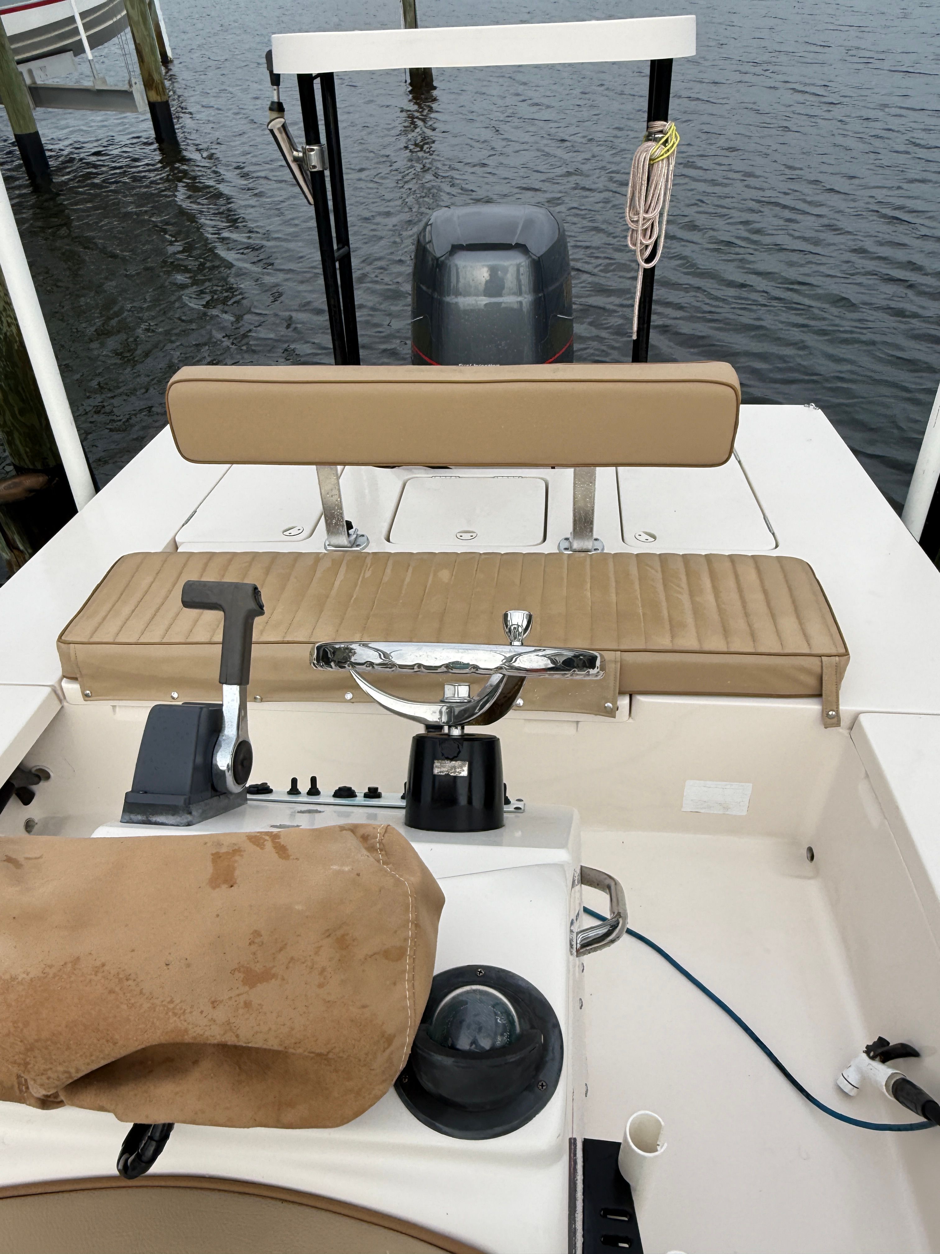 The image shows the cockpit of a 2003 Maverick 18 boat with beige upholstery.